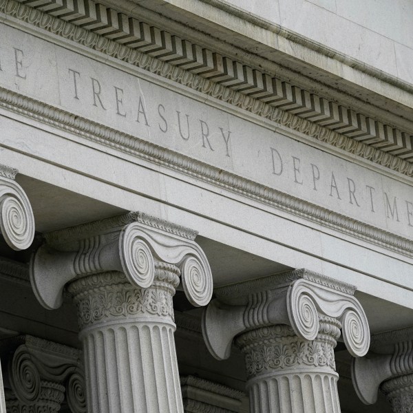 FILE - The Treasury Building is viewed in Washington, May 4, 2021. The Treasury Department is warning that state laws that restrict banks from considering environmental, social and governance factors could harm efforts to address money laundering and terrorism financing. The Associated Press obtained a copy of a letter sent Thursday to lawmakers. The letter single out a law signed by Florida Gov. Ron DeSantis in May that says it would be an “unsafe and unsound practice” for banks to consider non-financial factors when doing business. (AP Photo/Patrick Semansky, File)