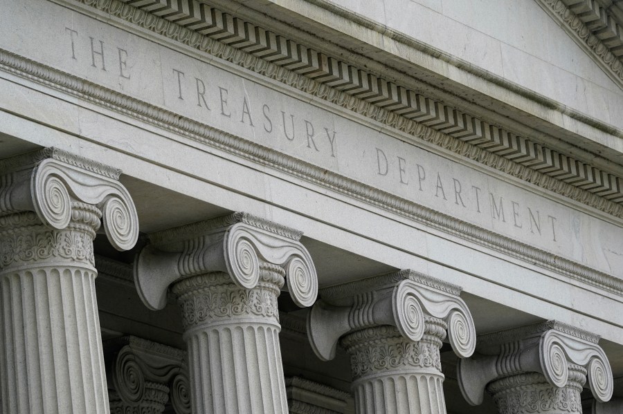 FILE - The Treasury Building is viewed in Washington, May 4, 2021. The Treasury Department is warning that state laws that restrict banks from considering environmental, social and governance factors could harm efforts to address money laundering and terrorism financing. The Associated Press obtained a copy of a letter sent Thursday to lawmakers. The letter single out a law signed by Florida Gov. Ron DeSantis in May that says it would be an “unsafe and unsound practice” for banks to consider non-financial factors when doing business. (AP Photo/Patrick Semansky, File)