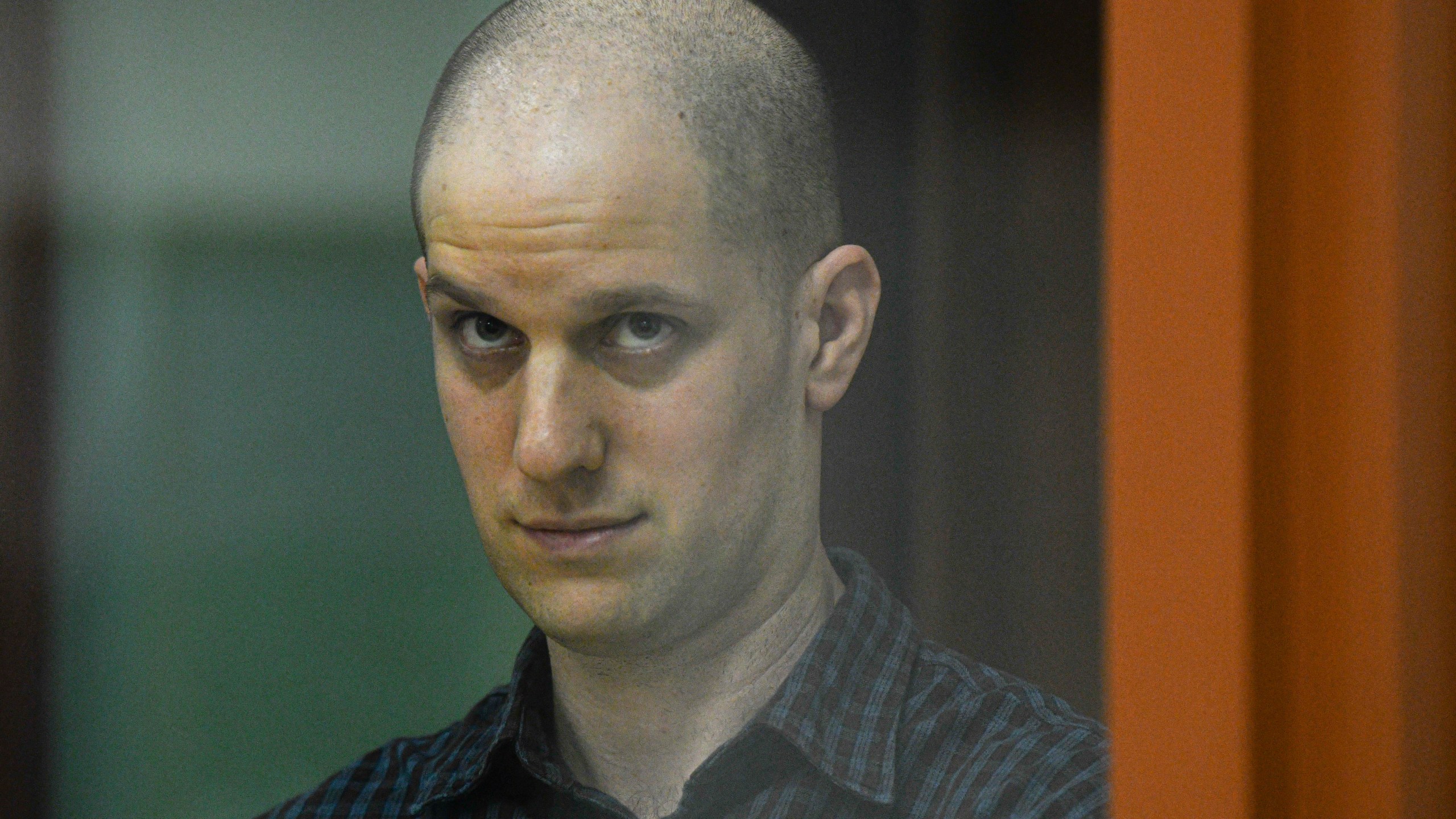 FILE - Wall Street Journal reporter Evan Gershkovich stands in a glass cage in a courtroom in Yekaterinburg, Russia, June 26, 2024. The U.S. Ambassador told Russia’s foreign minister on Tuesday, July 16, that President Vladimir Putin should release detained Americans, singling out Gershkovich and ex-Marine Paul Whelan and accusing the Russian leader of continuing to treat “human beings as bargaining chips.” (AP Photo, File)