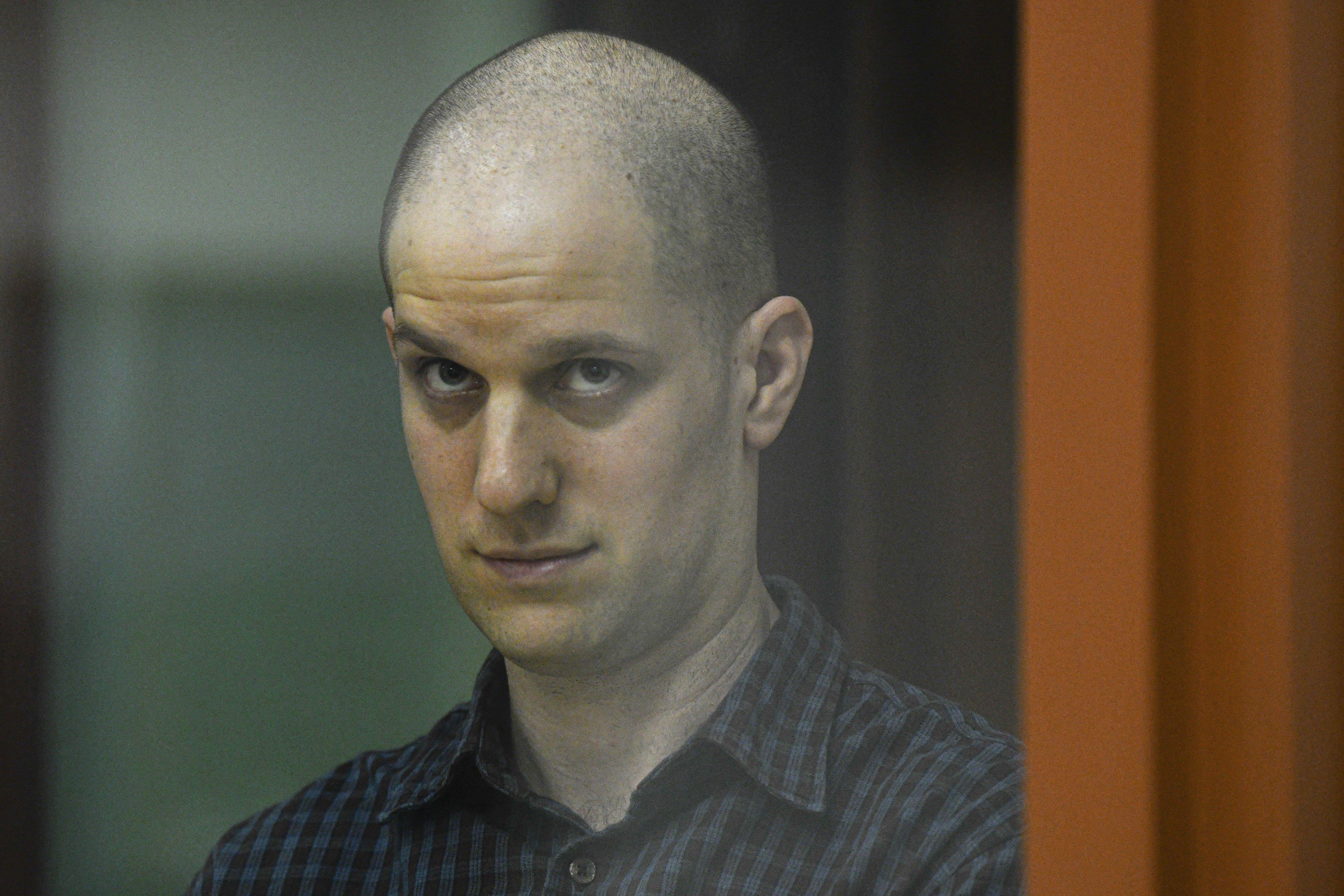 FILE - Wall Street Journal reporter Evan Gershkovich stands in a glass cage in a courtroom in Yekaterinburg, Russia, June 26, 2024. The U.S. Ambassador told Russia’s foreign minister on Tuesday, July 16, that President Vladimir Putin should release detained Americans, singling out Gershkovich and ex-Marine Paul Whelan and accusing the Russian leader of continuing to treat “human beings as bargaining chips.” (AP Photo, File)