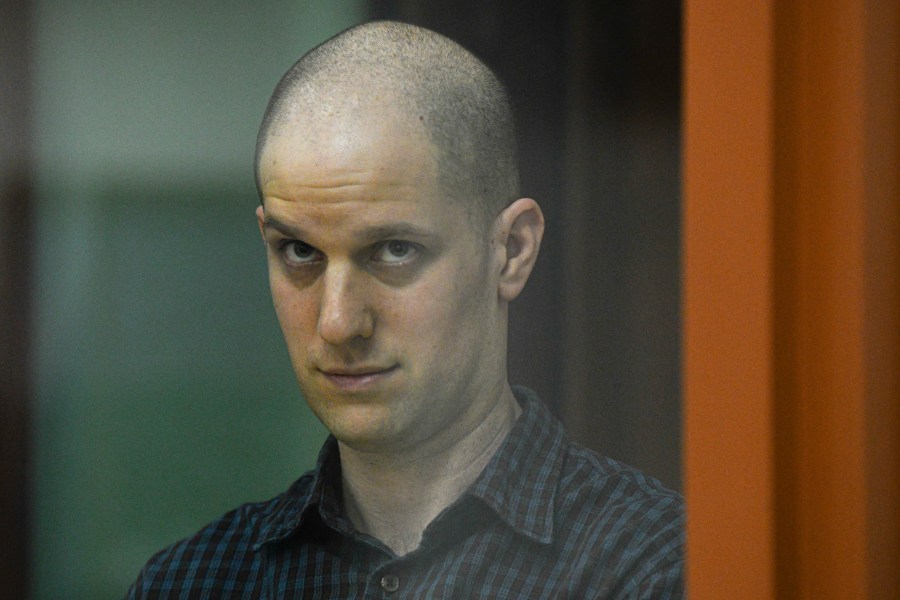 FILE - Wall Street Journal reporter Evan Gershkovich stands in a glass cage in a courtroom in Yekaterinburg, Russia, June 26, 2024. The U.S. Ambassador told Russia’s foreign minister on Tuesday, July 16, that President Vladimir Putin should release detained Americans, singling out Gershkovich and ex-Marine Paul Whelan and accusing the Russian leader of continuing to treat “human beings as bargaining chips.” (AP Photo, File)