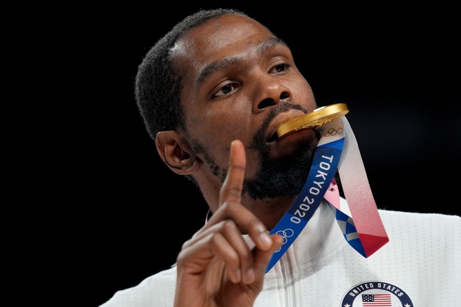 FILE - Kevin Durant poses for a photo with his gold medal during the medal ceremony for basketball game at the 2020 Summer Olympics, Aug. 7, 2021, in Tokyo, Japan. (AP Photo/Eric Gay, File)