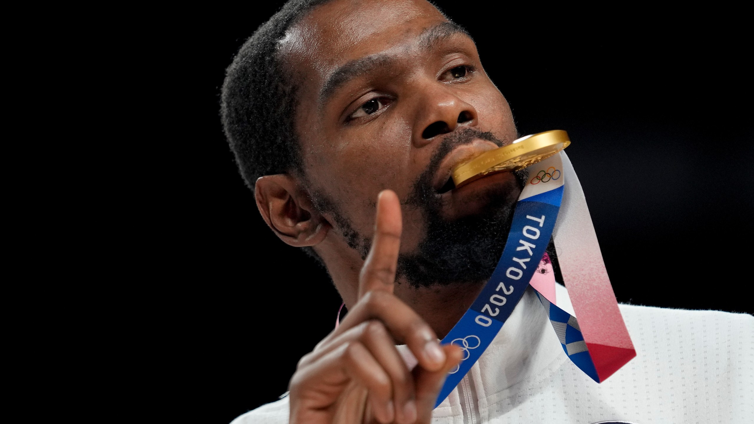 FILE - Kevin Durant poses for a photo with his gold medal during the medal ceremony for basketball game at the 2020 Summer Olympics, Aug. 7, 2021, in Tokyo, Japan. (AP Photo/Eric Gay, File)