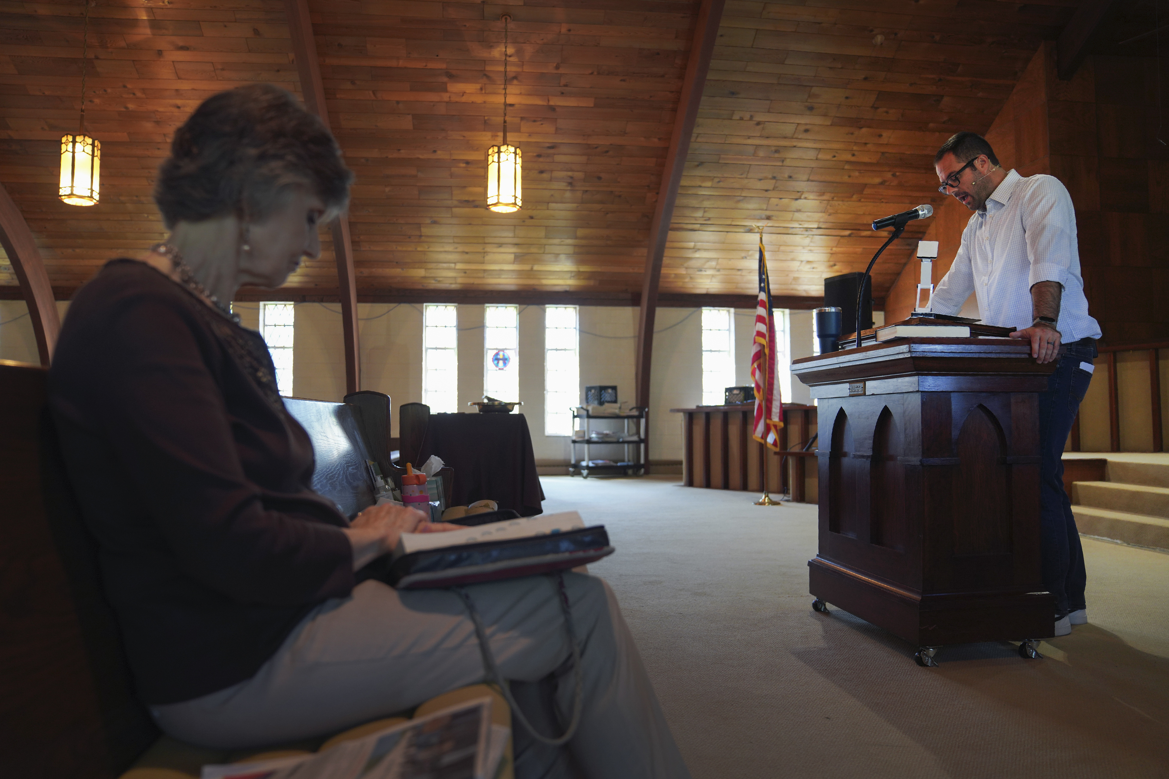 FILE - Gail Farnham, left, listens as Pastor Ryan Burge preaches a sermon at First Baptist Church in Mt. Vernon, Ill., Sept. 10, 2023. Burge is an associate professor of political science at Eastern Illinois University and author of "The Nones." (AP Photo/Jessie Wardarski, File)