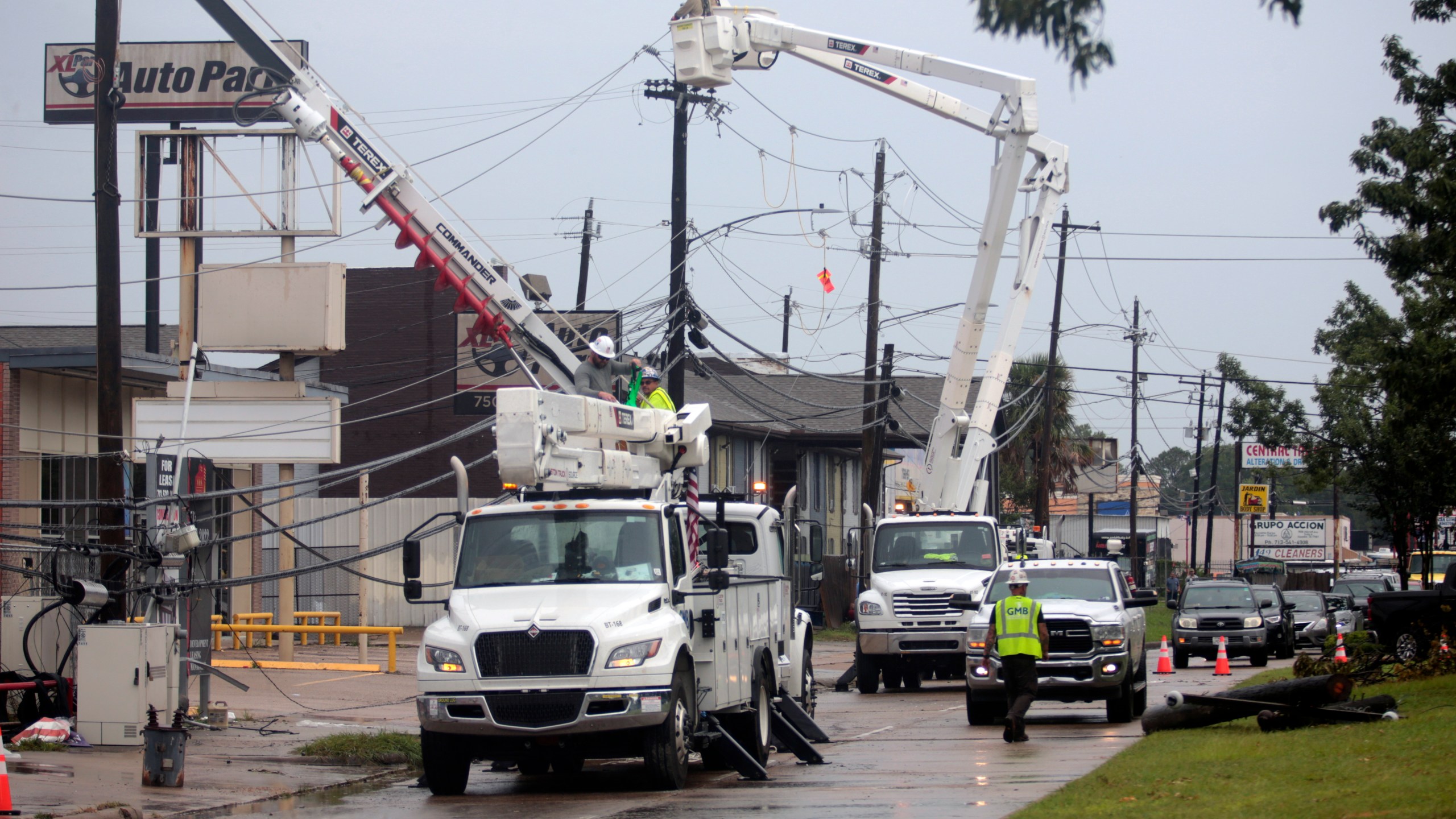 FILE - Utility crews work to restore electricity in Houston, Thursday, July 11, 2024. As of Thursday, July 18, most Houston residents finally had electricity after more than a week of widespread outages. (AP Photo/Lekan Oyekanmi, File)