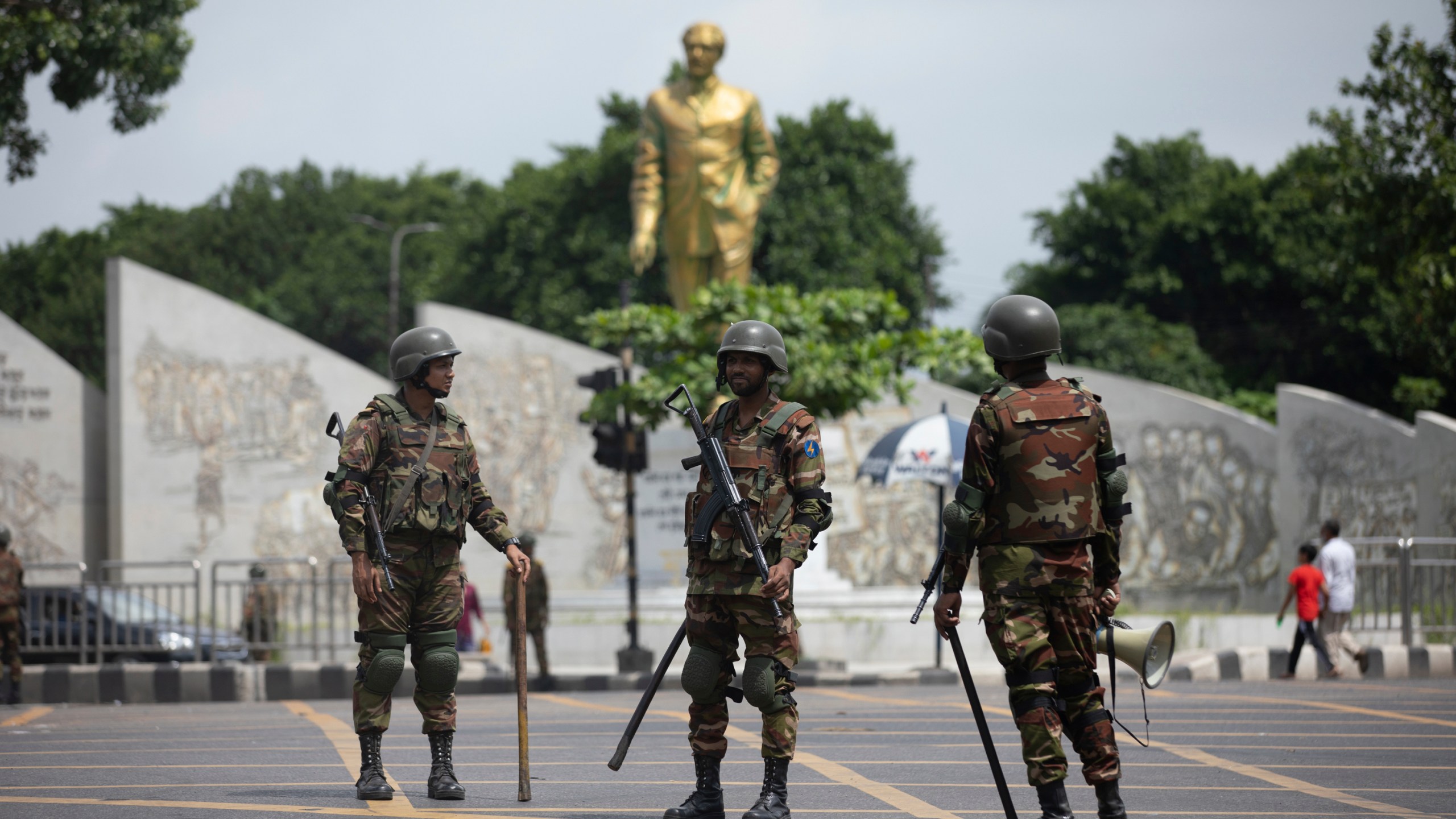 Bangladeshi military forces soldiers patrol on a street in Dhaka, Bangladesh, Saturday, July 20, 2024. Bangladeshi authorities extended a curfew across the country on Sunday as the nation's top court was expected to rule on a civil service hiring quota that has led to days of deadly clashes between police and protesters, killing scores of people.(AP Photo/Rajib Dhar)