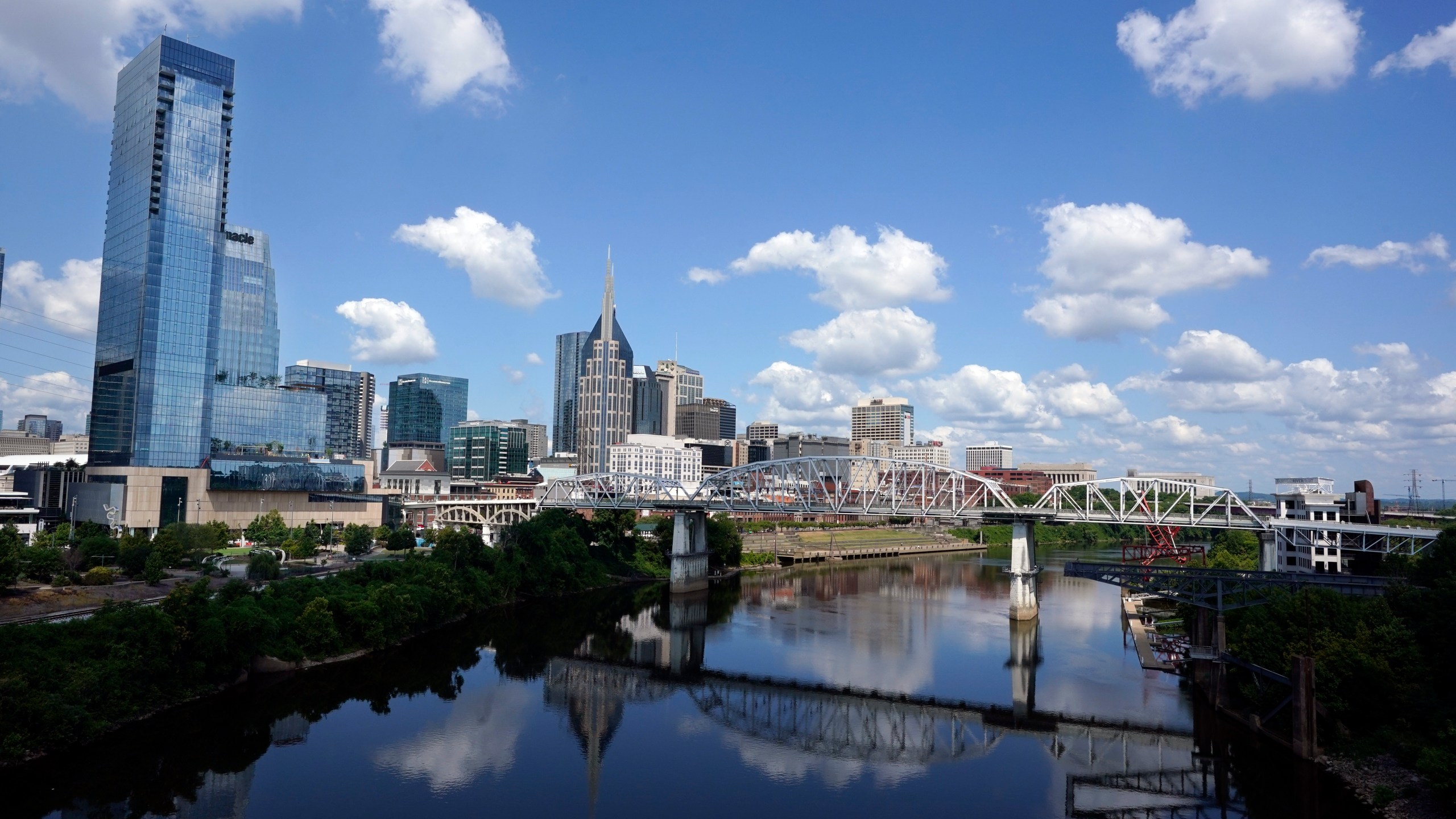 FILE - The Nashville, Tenn., skyline is reflected in the Cumberland River July 11, 2022. A panel of judges has struck down a 2023 change approved by Tennessee Republican lawmakers that would cut the size of Democratic-leaning Nashville’s Metro Council in half. The decision Monday, July 29, 2024, marks another court defeat for a series of state laws passed last year to cut into Nashville’s autonomy, extending to its international airport and pro sports facilities. (AP Photo/Mark Humphrey, File)