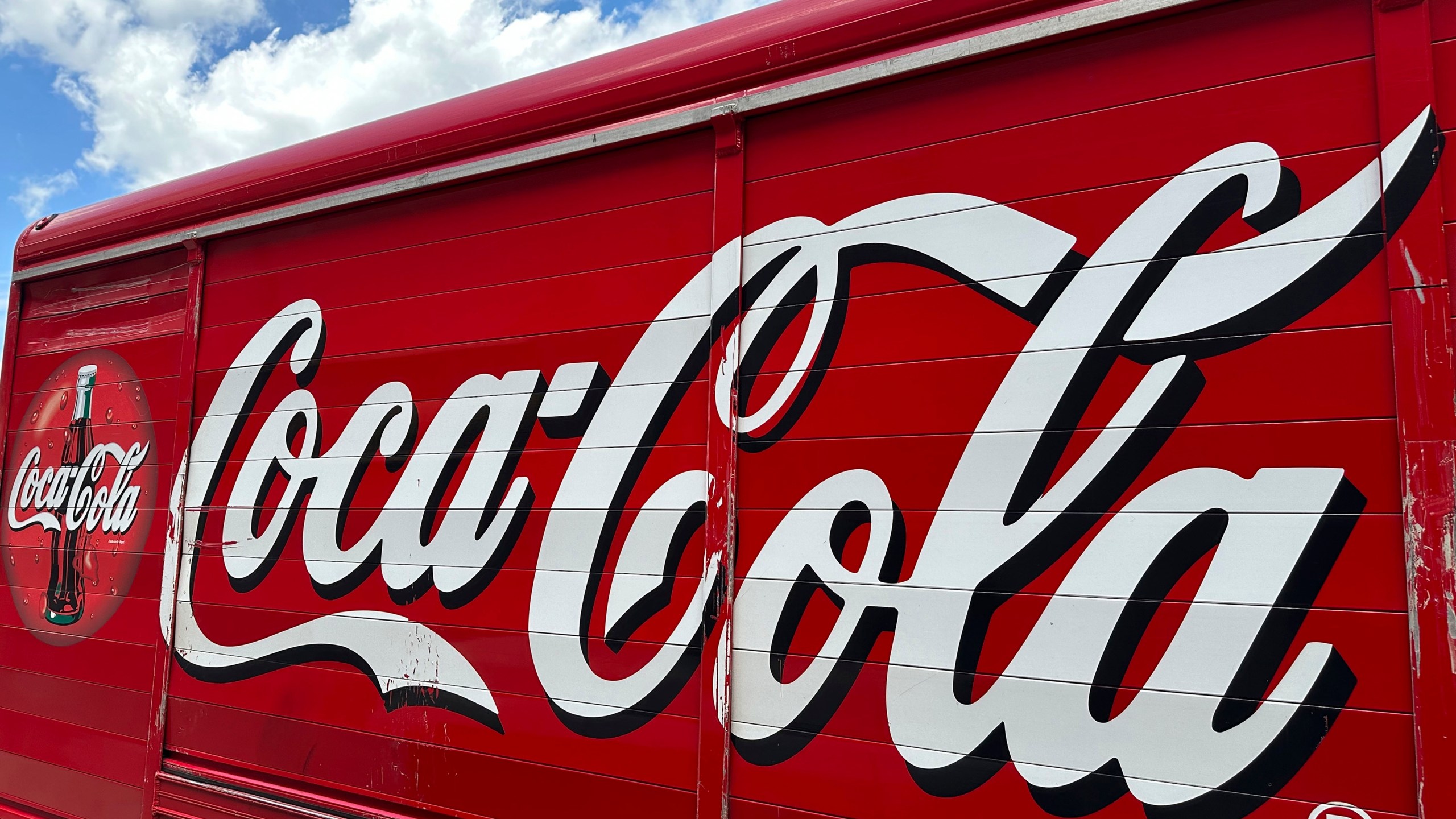 FILE - The Coca-Cola logo adorns the side of a delivery truck May 15, 2024, in southeast Denver. Coca-Cola reports earnings on Tuesday, July 23, 2024. Coca-Cola Co. said Friday, Aug. 2, 2024, it will pay a back tax bill amounting to $6 billion to the Internal Revenue Service while it appeals a federal tax court judge's latest ruling in a case dating back 17 years. (AP Photo/David Zalubowski, File)