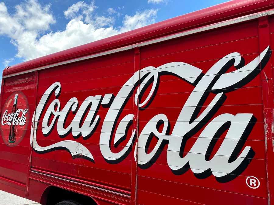 FILE - The Coca-Cola logo adorns the side of a delivery truck May 15, 2024, in southeast Denver. Coca-Cola reports earnings on Tuesday, July 23, 2024. Coca-Cola Co. said Friday, Aug. 2, 2024, it will pay a back tax bill amounting to $6 billion to the Internal Revenue Service while it appeals a federal tax court judge's latest ruling in a case dating back 17 years. (AP Photo/David Zalubowski, File)