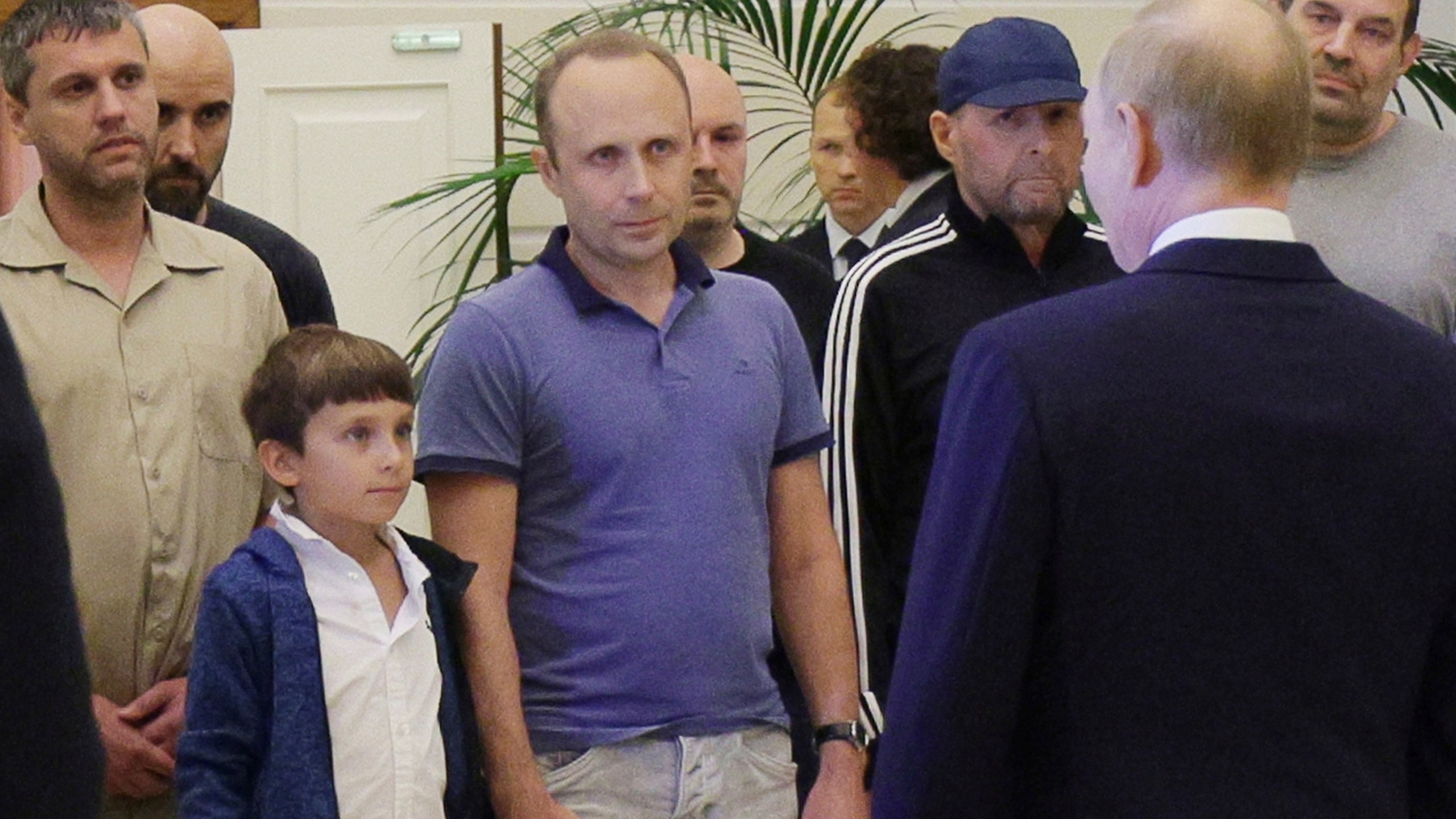 A man identified as Pablo González, a freelance journalist from Spain who had been based in Poland since 2019, second from left with shaved head, listens to Russian President Vladimir Putin, back to a camera, speaking to released Russian prisoners, part of the biggest prisoner swap between the United States and Russia in post-Soviet history, upon their arrival at the Vnukovo government airport outside Moscow, Russia, on Thursday, Aug. 1, 2024. Gonzalez had another passport and another name: Pavel Rubtsov. (Gavriil Grigorov, Sputnik, Kremlin Pool Photo via AP)