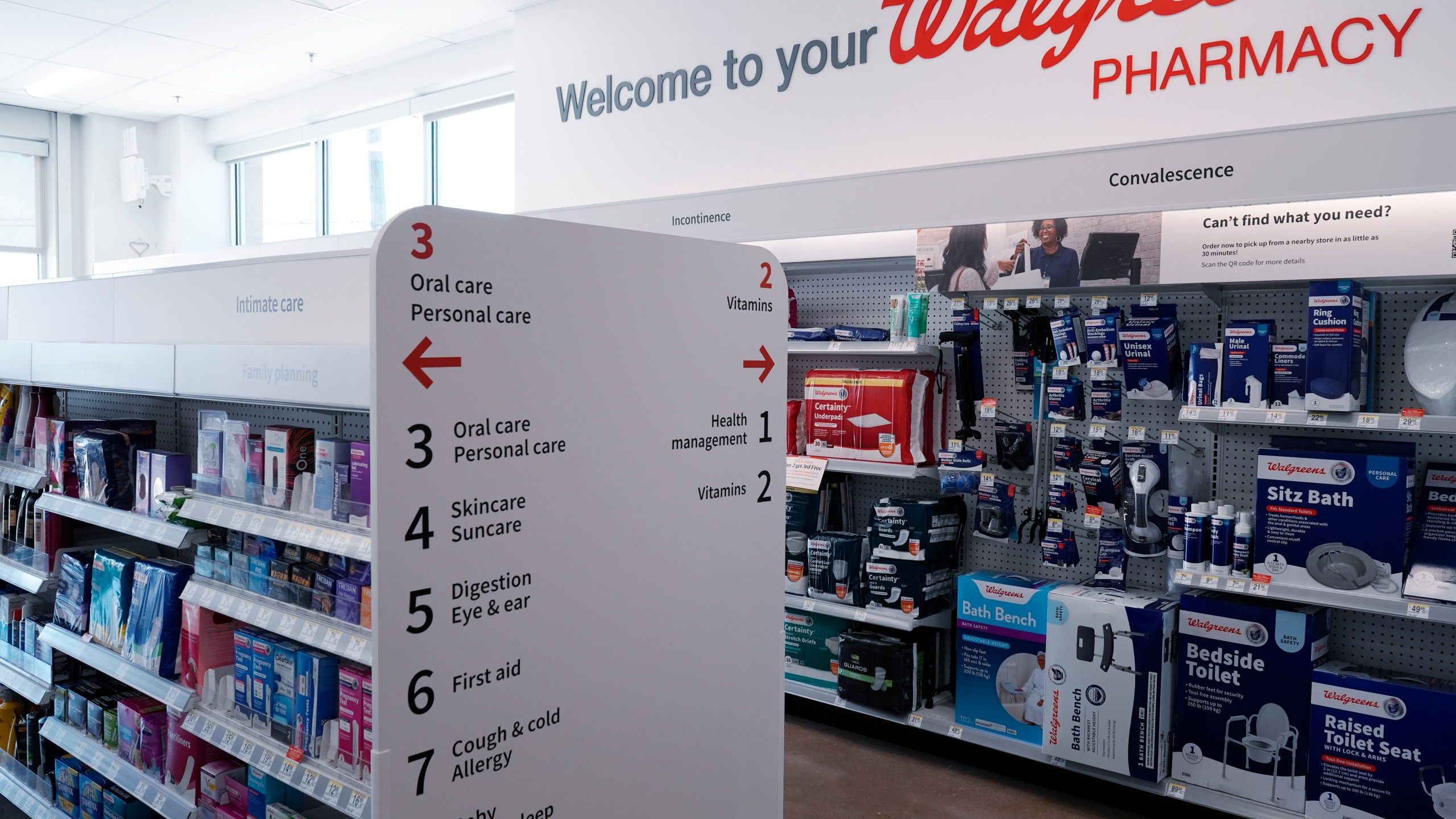 Aisle information signs are seen at a Walgreens pharmacy store in Deerfield, Ill., Thursday, July 25, 2024. (AP Photo/Nam Y. Huh)