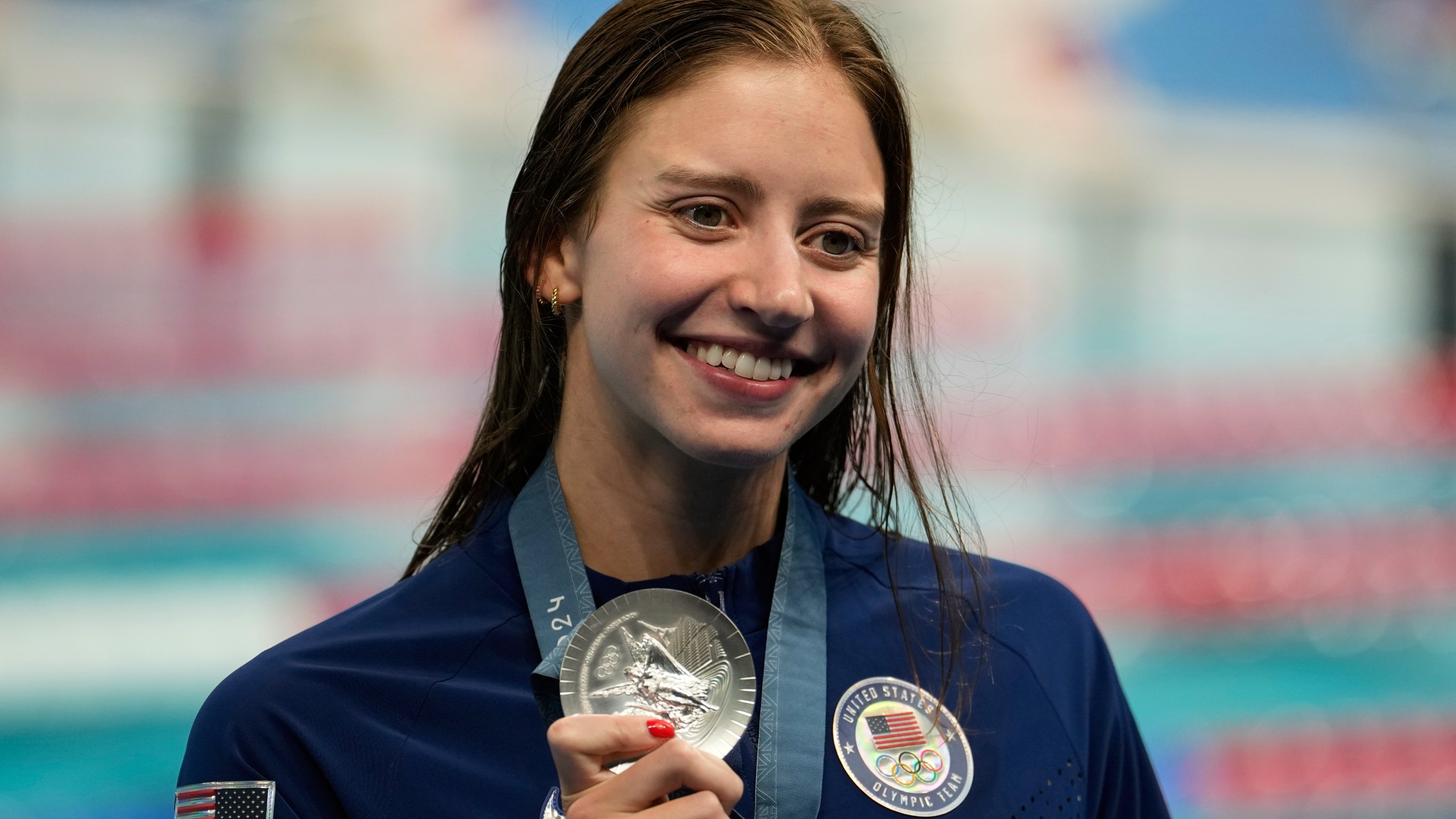 United States' Kate Douglass celebrates with the silver medal during the awards ceremony for the women's 200-meter individual medley at the Summer Olympics in Nanterre, France, Saturday, Aug. 3, 2024. (AP Photo/Brynn Anderson)