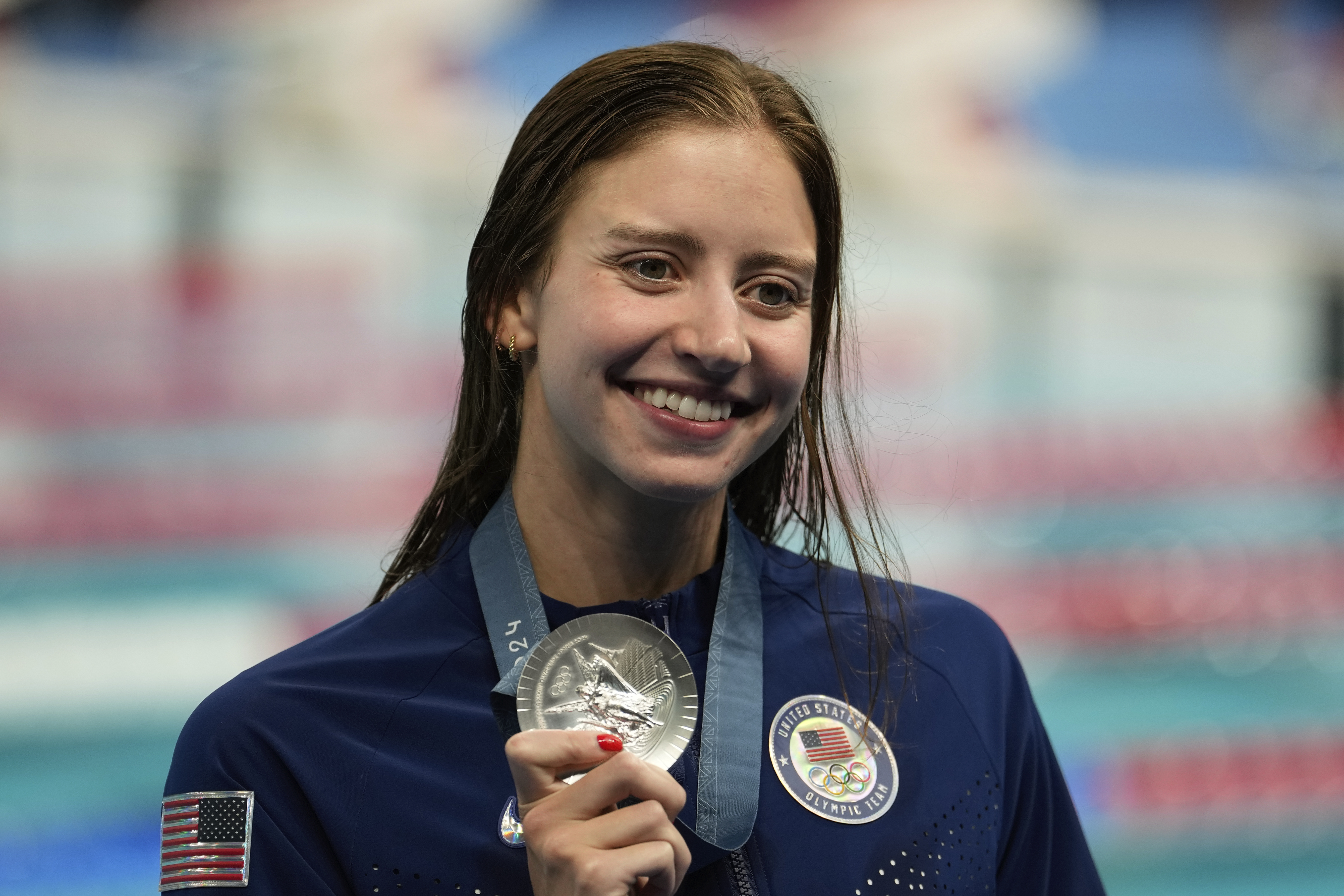 United States' Kate Douglass celebrates with the silver medal during the awards ceremony for the women's 200-meter individual medley at the Summer Olympics in Nanterre, France, Saturday, Aug. 3, 2024. (AP Photo/Brynn Anderson)