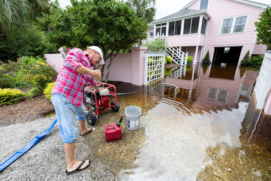 Robert Chesnut starts his water pump at his Palm Blvd. home after it was flooded by Tropical Storm Debby Thursday, Aug. 8, 2024, in Isle of Palms, S.C. (AP Photo/Mic Smith)