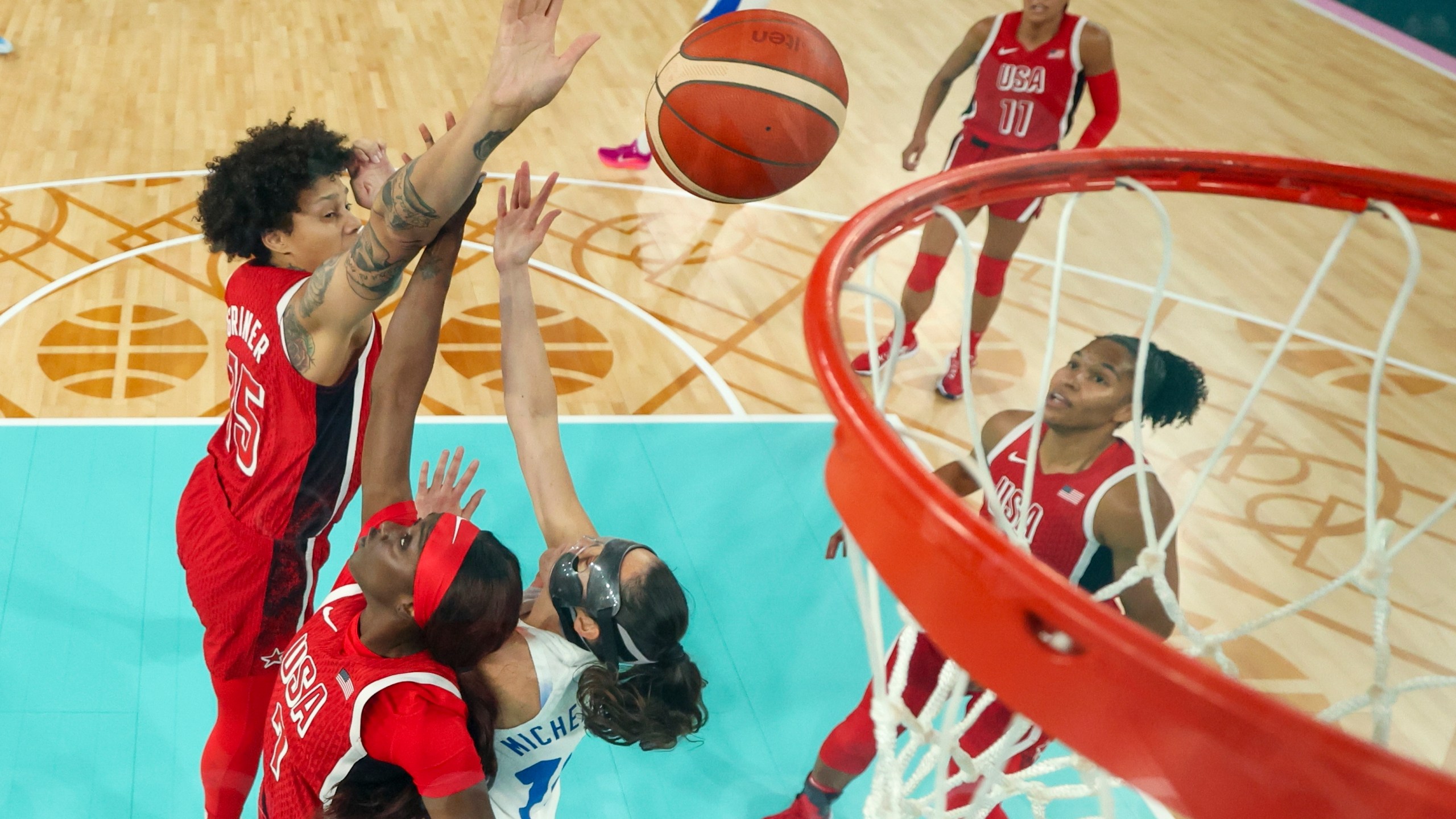 United States' Brittney Griner, left, (15) and United States' Kahleah Copper (7) block a shot form Sarah Michel Boury, right, (10), of France, during a women's gold medal basketball game between the United States and France at Bercy Arena at the 2024 Summer Olympics, Sunday, Aug. 11, 2024, in Paris, France. (Gregory Shamus/Pool Photo via AP)