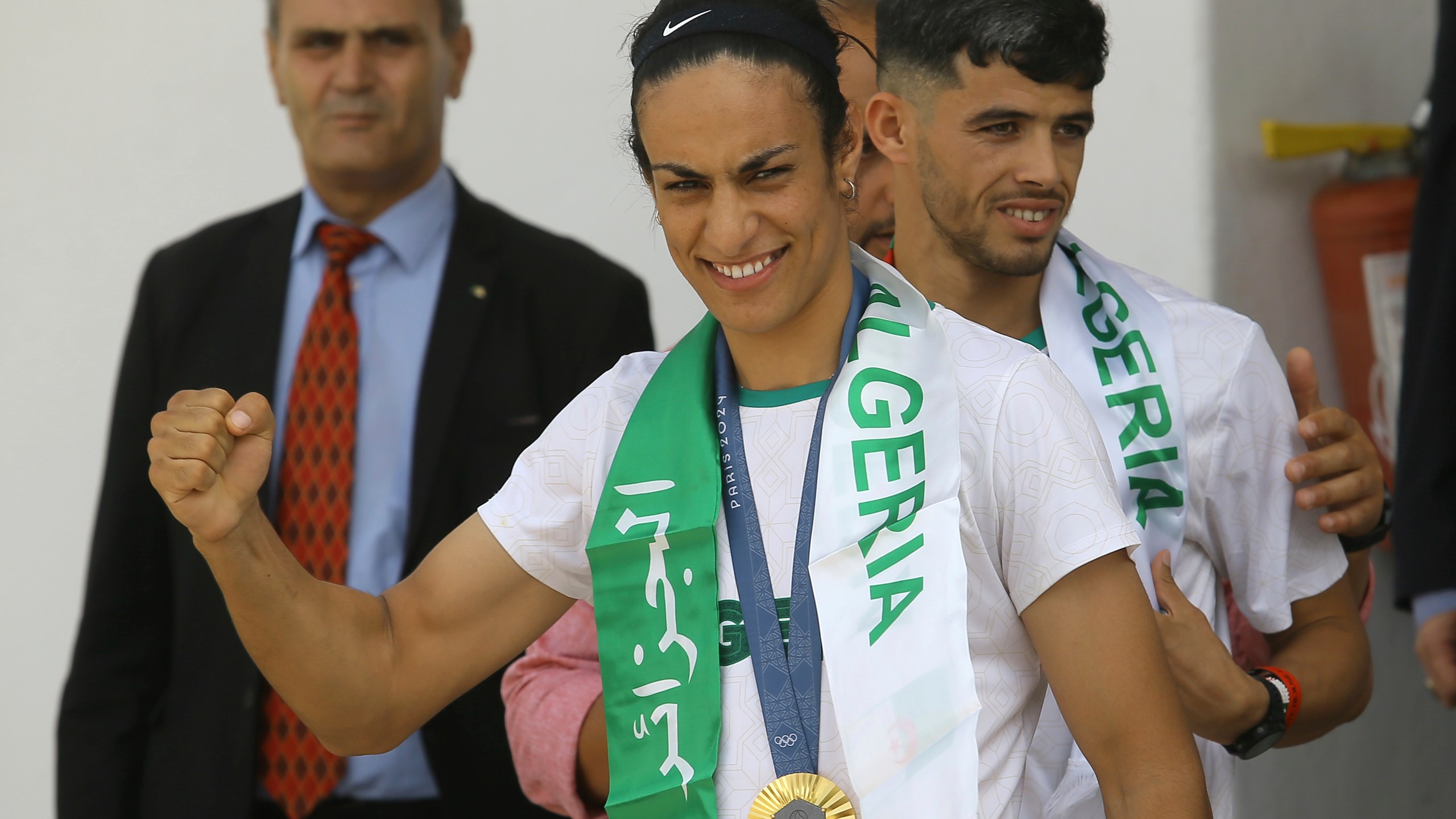 Gold medalist in the the women's 66 kg boxing Algeria's Imane Khelif, left, and bronze medalist in the men's 800m Djamel Sedjati arrive after the 2024 Summer Olympics, Monday, Aug. 12, 2024, at Algiers airport, Algeria. (AP Photo/Anis Belghoul)