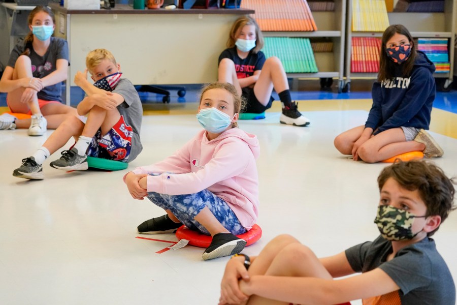 FILE - Fifth graders wearing face masks are seated at proper social distancing during a music class at the Milton Elementary School in Rye, N.Y., May 18, 2021. (AP Photo/Mary Altaffer, File)