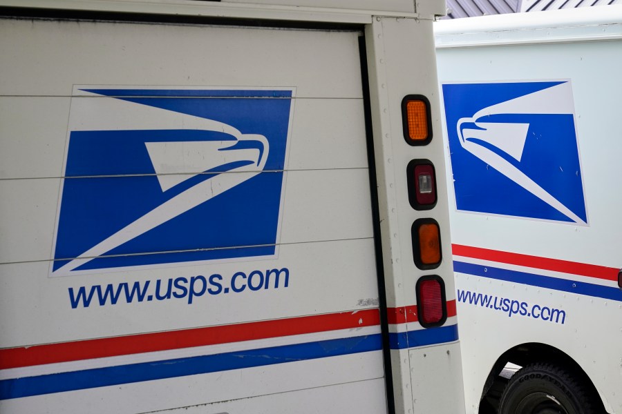 FILE - U.S. Postal Service delivery vehicles are parked outside a post office in Boys Town, Neb., Aug. 18, 2020. (AP Photo/Nati Harnik, File)