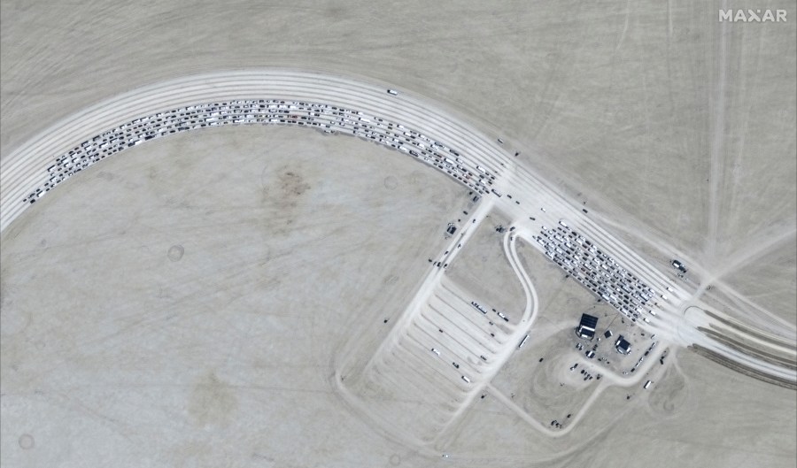 This image released by Maxar Technologies shows vehicles waiting to enter Burning Man 2024 festival, Sunday, Aug. 25, 2024, in Black Rock City, Nev. (Satellite image ©2024 Maxar Technologies via AP)