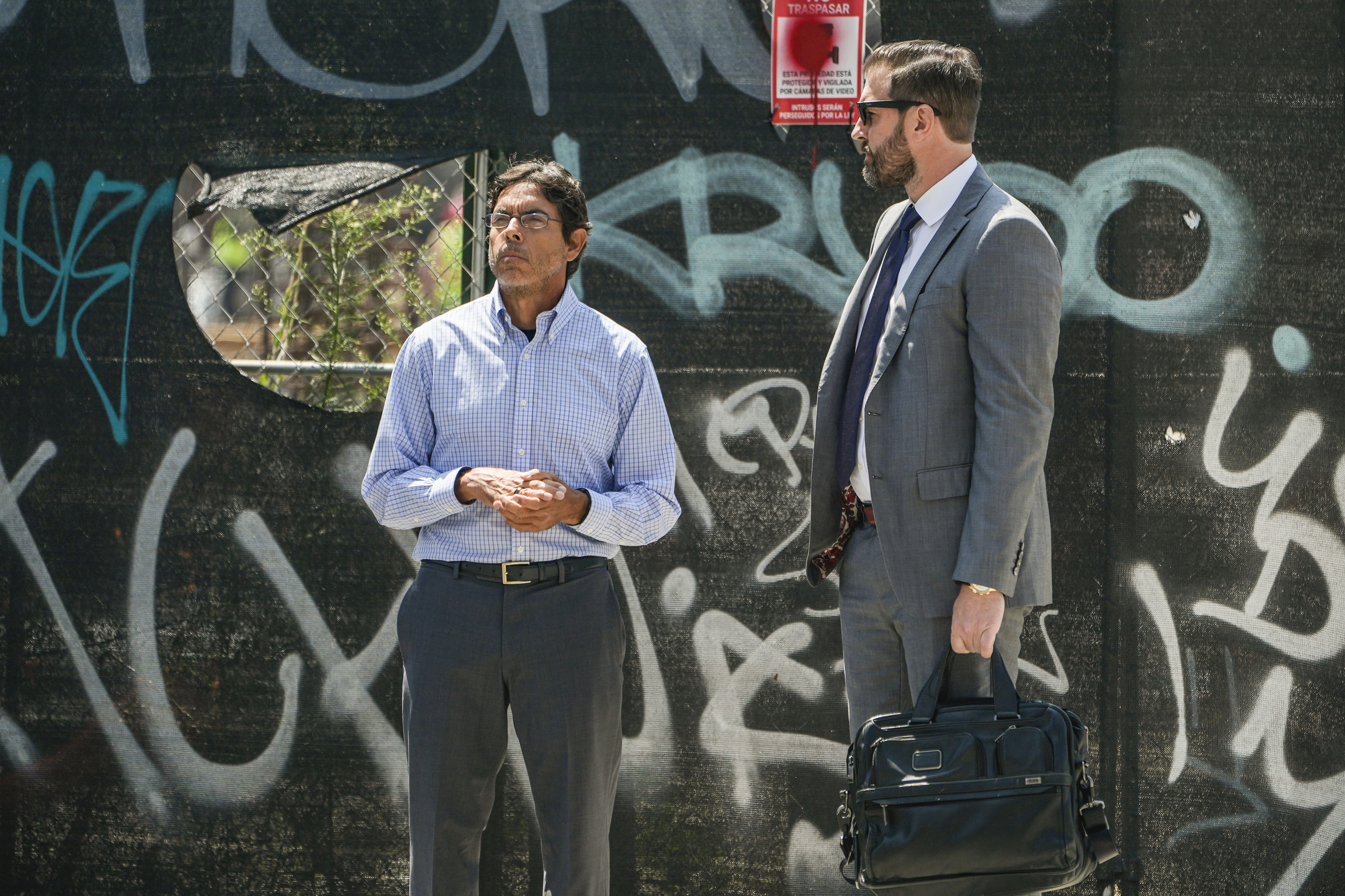 Dr. Mark Chavez, left, a physician from San Diego, who is charged in connection with actor Matthew Perry's death from an accidental ketamine overdose, waits to cross the street with his attorney Matthew Binninger across from the Roybal Federal Courthouse in Los Angeles, Friday, Aug. 30, 2024. (AP Photo/Damian Dovarganes)