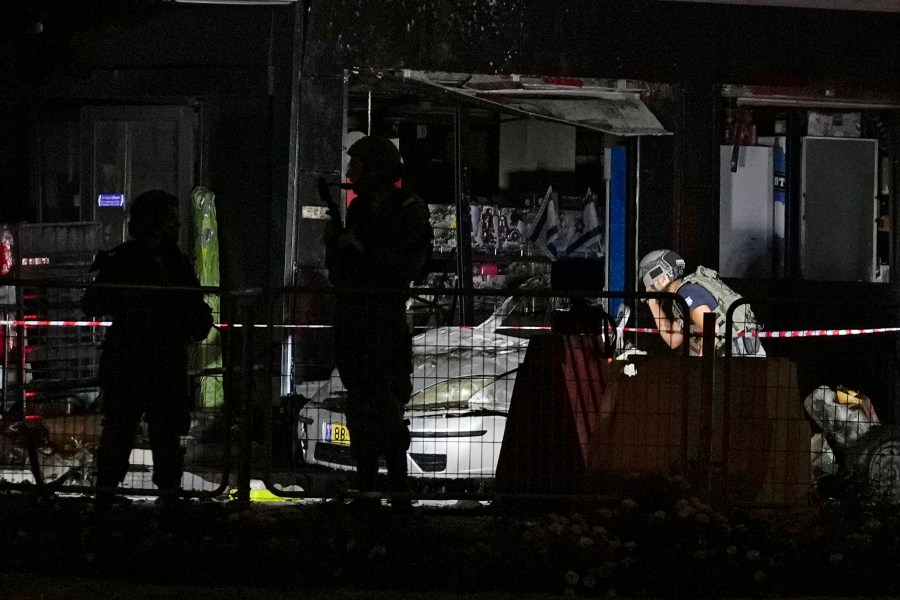 Israeli security forces examine a car after an explosion at a gas station in the West Bank settlement of Gush Etzion, Saturday, Aug. 31, 2024. (AP Photo/Ohad Zwigenberg)