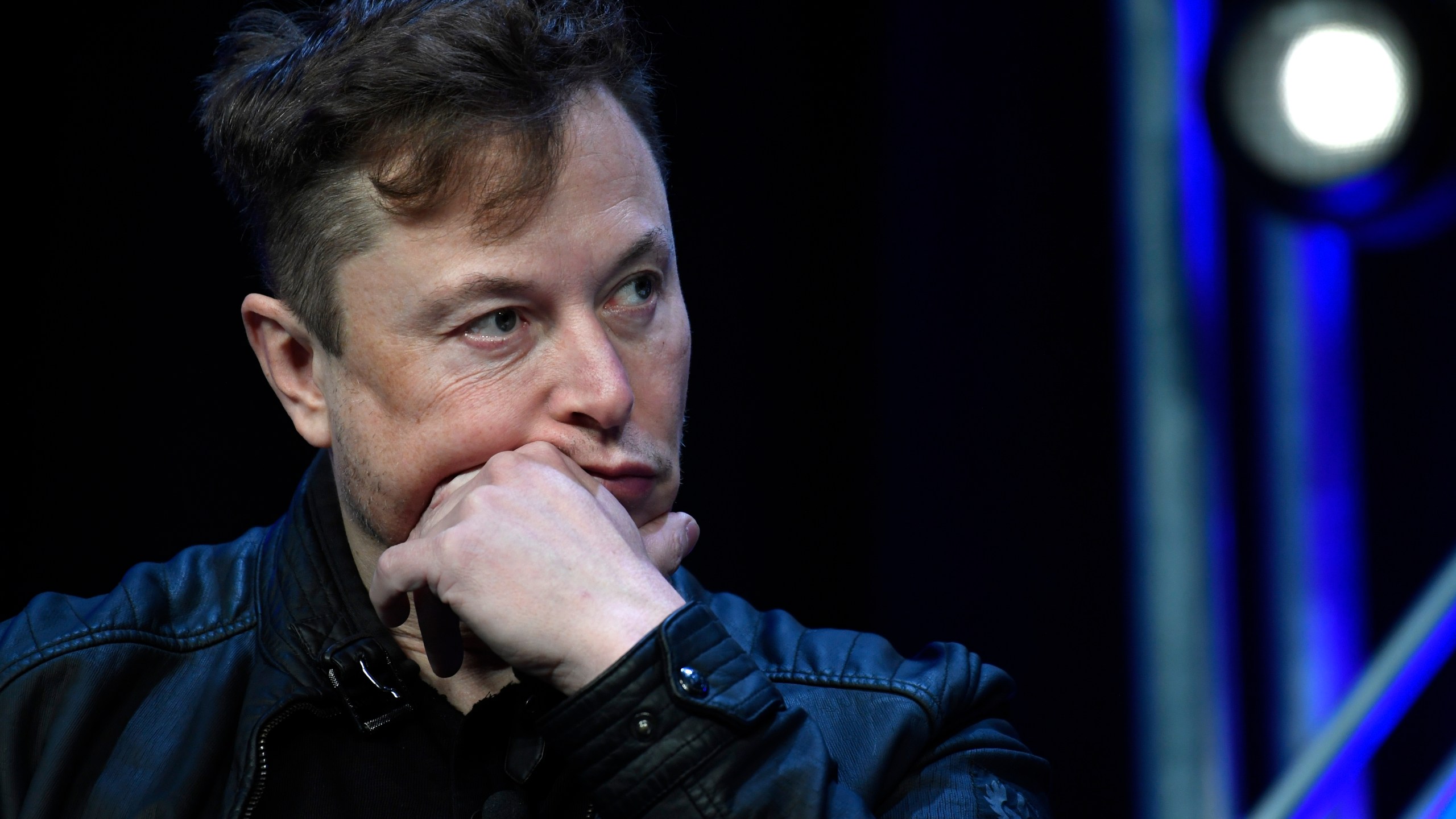 FILE - Tesla and SpaceX chief executive officer Elon Musk listens to a question as he speaks at the SATELLITE Conference and Exhibition in Washington, March 9, 2020. (AP Photo/Susan Walsh, File)