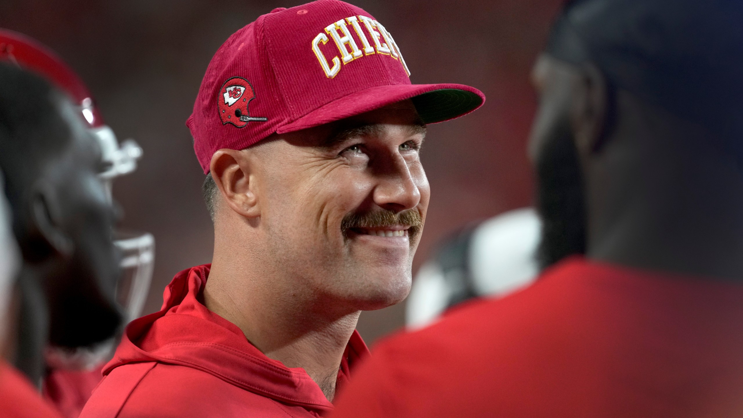 Kansas City Chiefs tight end Travis Kelce smiles on the sidelines during the first half of an NFL preseason football game against the Chicago Bears Thursday, Aug. 22, 2024, in Kansas City, Mo. (AP Photo/Ed Zurga)