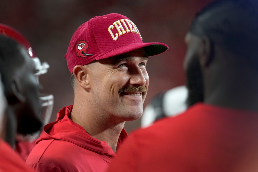 Kansas City Chiefs tight end Travis Kelce smiles on the sidelines during the first half of an NFL preseason football game against the Chicago Bears Thursday, Aug. 22, 2024, in Kansas City, Mo. (AP Photo/Ed Zurga)