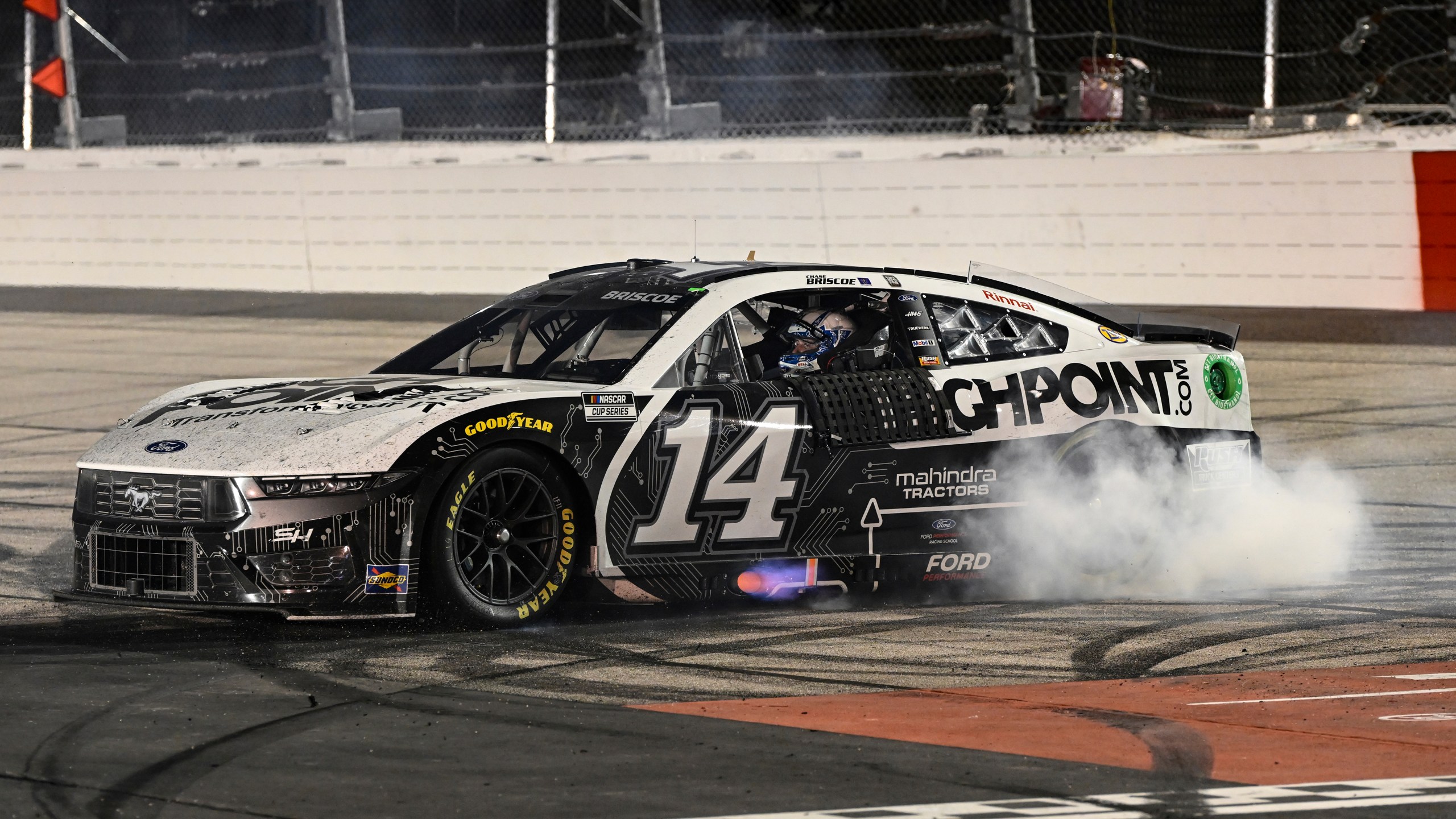 Chase Briscoe does a burnout after winning a NASCAR Cup Series auto race at Darlington Raceway, Sunday, Sept. 1, 2024, in Darlington, S.C. (AP Photo/Matt Kelley)