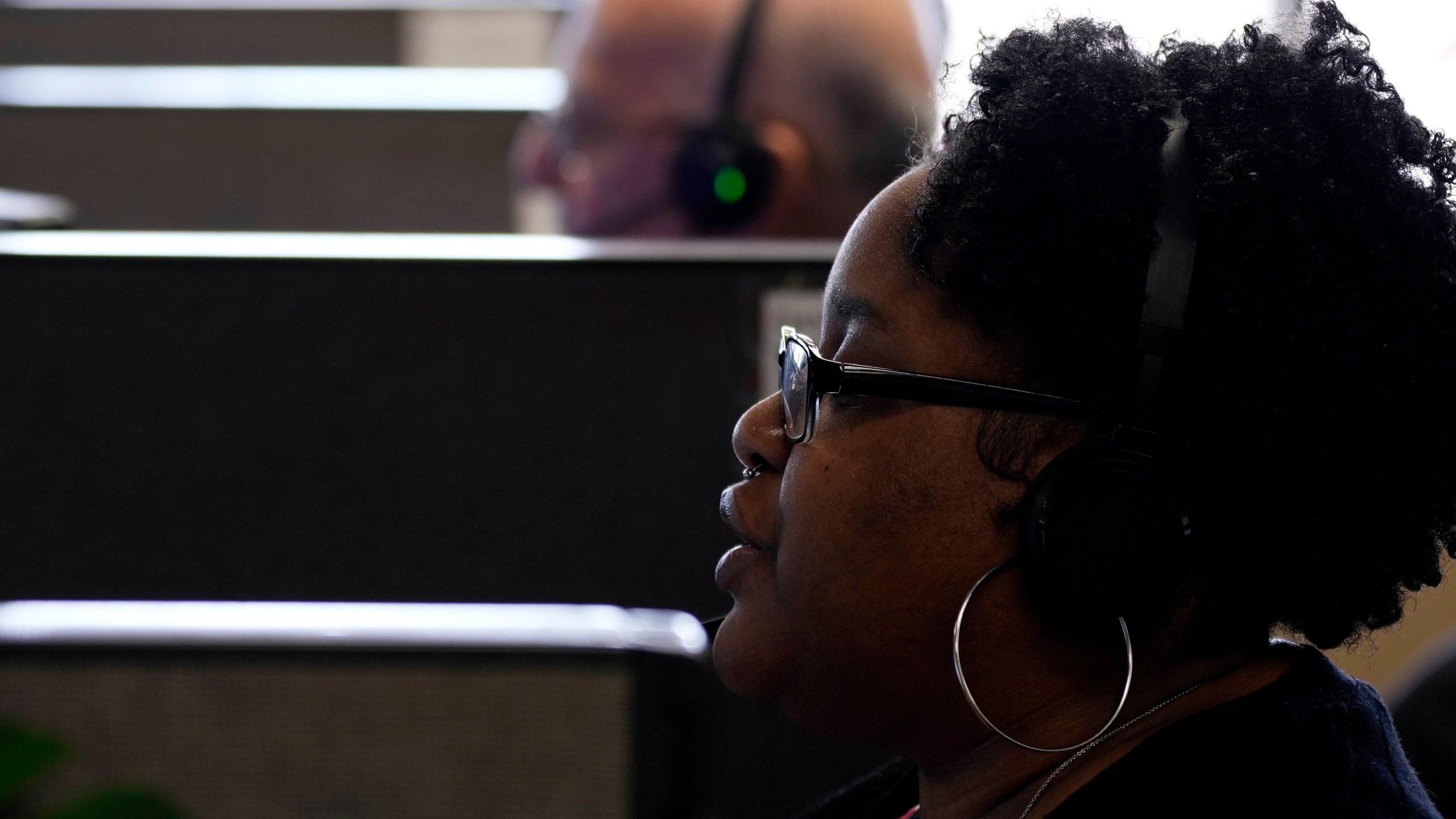 Customer Experience Representative Cassia Jones-Woodard takes calls at an Alorica center, Monday, Aug. 19, 2024, in San Antonio. (AP Photo/Eric Gay)