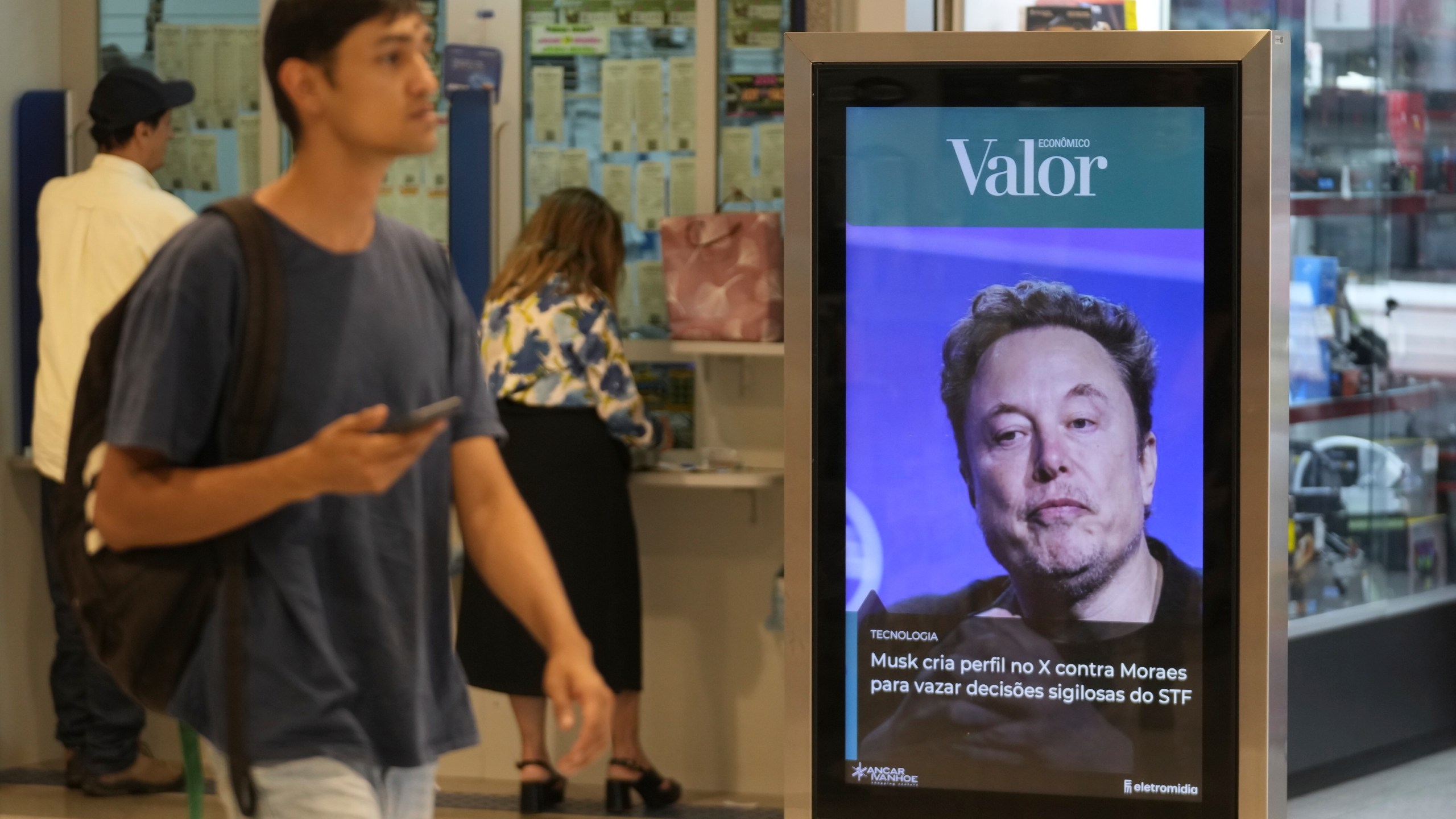 An ad by Valor media shows a photo of Elon Musk at a shopping center in Brasilia, Brazil, Monday, Sept. 2, 2024. The sign reads in Portuguese: "Musk creates profile on X against Moraes to leak confidential decisions of the Supreme Court," referring to Supreme Court Justice Alexandre de Moraes who ordered the platform blocked for having failed to name a local legal representative as required by law. (AP Photo/Eraldo Peres)