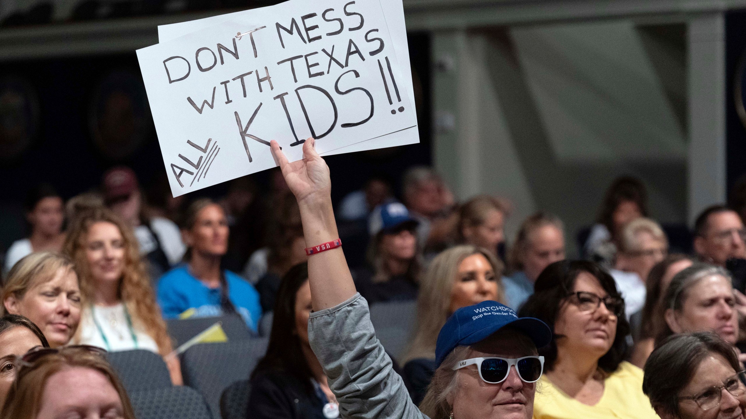 An attendee holds up a sign at the Moms for Liberty National Summit in Washington, Saturday, Aug. 31, 2024. (AP Photo/Jose Luis Magana)