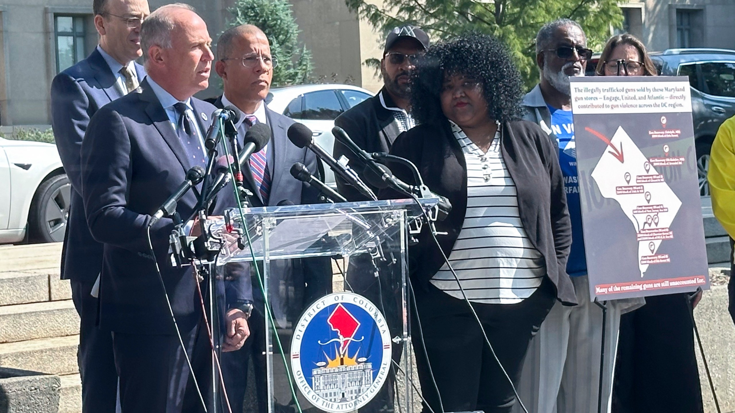 Brian Schwalb, attorney general for the District of Columbia, center left, and Maryland Attorney General Anthony Brown, to his right, speak outside the federal courthouse, Tuesday, Sept. 3, 2024 in Washington. Three gun shops that sold dozens of firearms to a man who trafficked the weapons in and around Washington, D.C., are facing a new lawsuit filed jointly Tuesday by attorneys general for Maryland and the nation’s capital. (AP Photo/Lindsay Whitehurst)