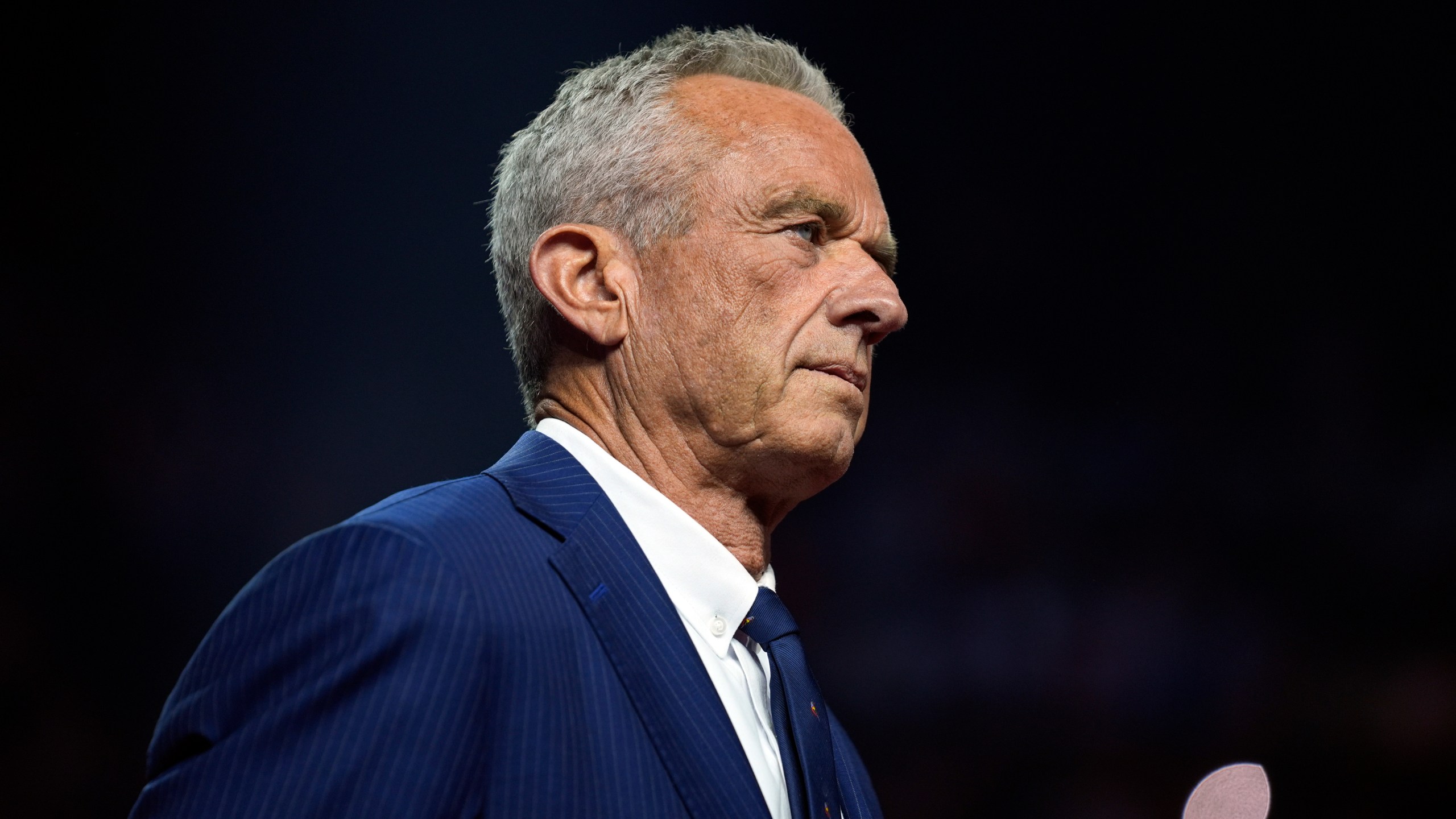 FILE - Independent presidential candidate Robert F. Kennedy Jr. listens before endorsing Republican presidential nominee former President Donald Trump at a campaign rally at the Desert Diamond Arena, Friday, Aug. 23, 2024, in Glendale, Ariz. (AP Photo/Evan Vucci, File)