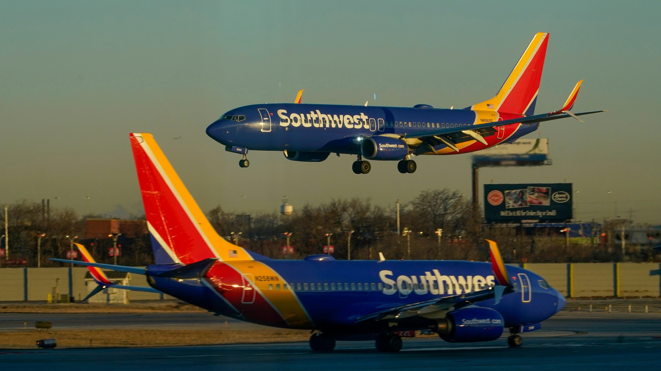 FILE - A Southwest Airlines plane prepares to land at Midway International Airport while another taxis on the ground, Feb. 12, 2023, in Chicago. (AP Photo/Kiichiro Sato, File)