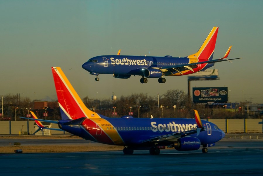 FILE - A Southwest Airlines plane prepares to land at Midway International Airport while another taxis on the ground, Feb. 12, 2023, in Chicago. (AP Photo/Kiichiro Sato, File)