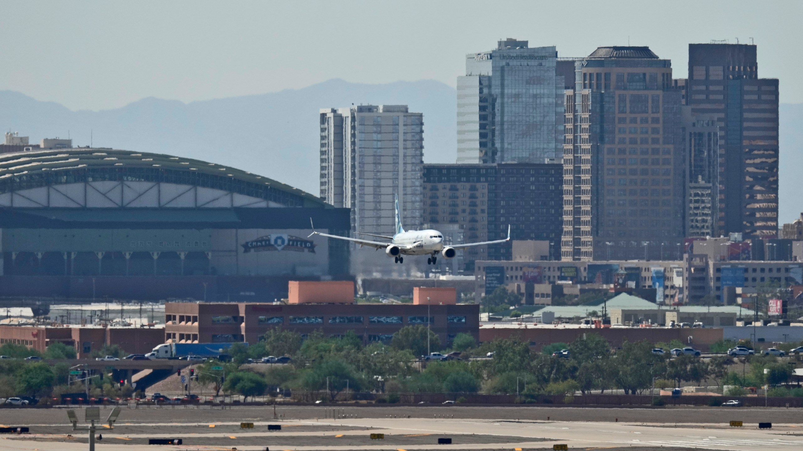 Downtown Phoenix is obscured by heat ripples as a jet lands at Sky Harbor International Airport, Tuesday, Sept. 3, 2024, in Phoenix. (AP Photo/Matt York)