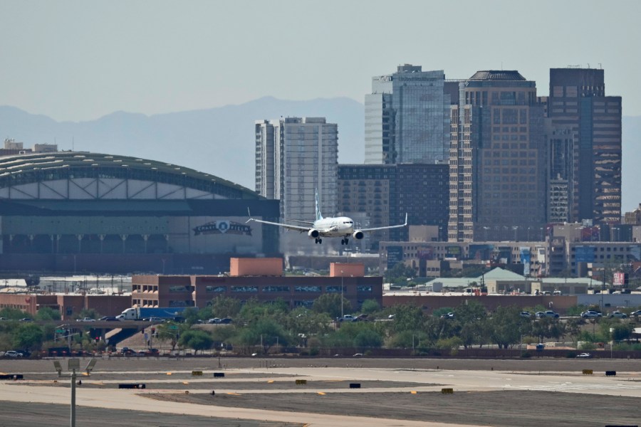 Downtown Phoenix is obscured by heat ripples as a jet lands at Sky Harbor International Airport, Tuesday, Sept. 3, 2024, in Phoenix. (AP Photo/Matt York)