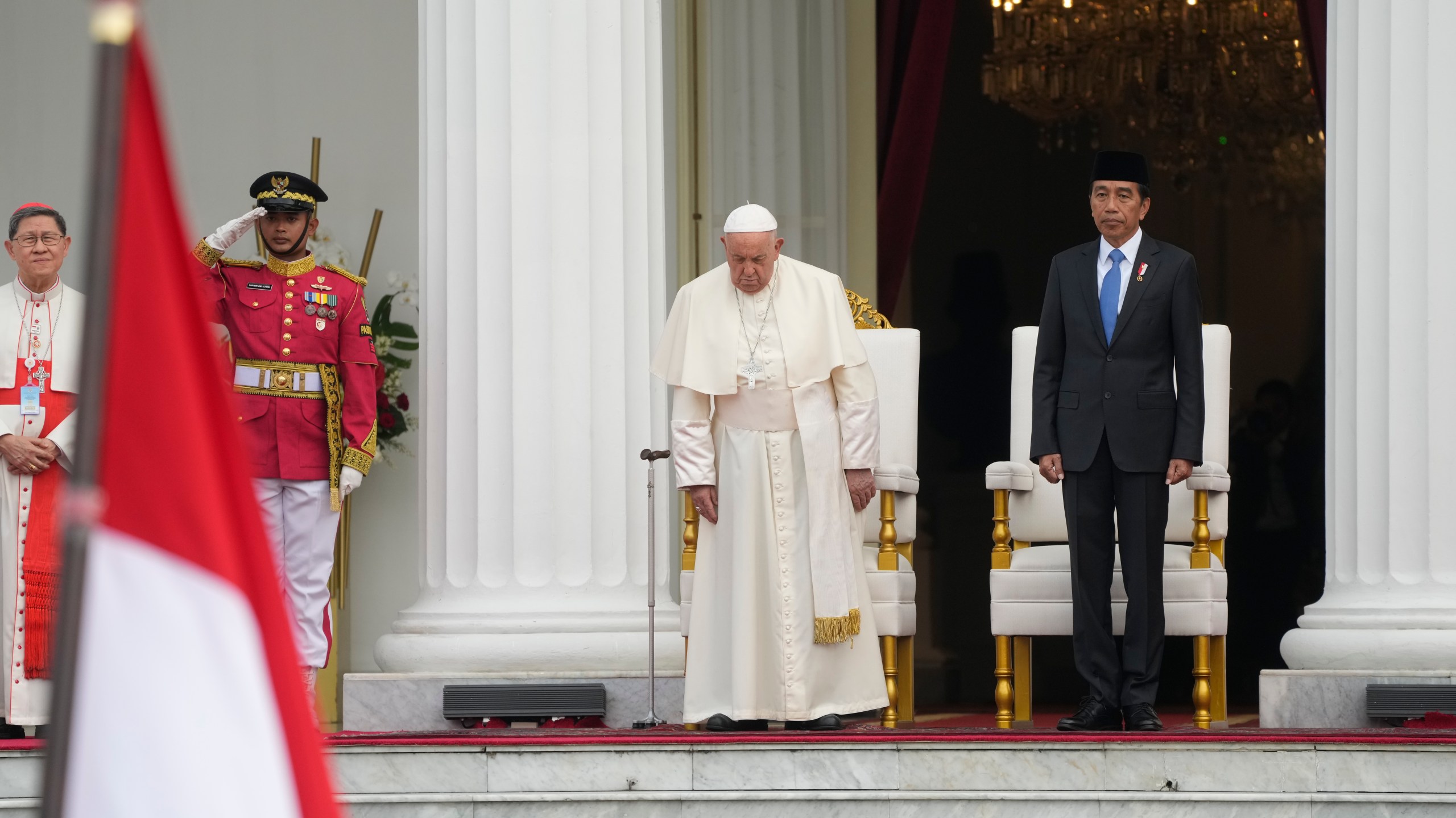 Indonesian President Joko Widodo, right, receives Pope Francis, center, at Istana Merdeka Presidential Palace in Jakarta, Wednesday, Sept. 4, 2024. Pope Francis is opening his visit to Indonesia with a packed first day Wednesday, meeting political and religious leaders and setting a rigorous pace for an 11-day, four-nation trip through tropical Asia and Oceania that will test his stamina and health. (AP Photo/Gregorio Borgia)