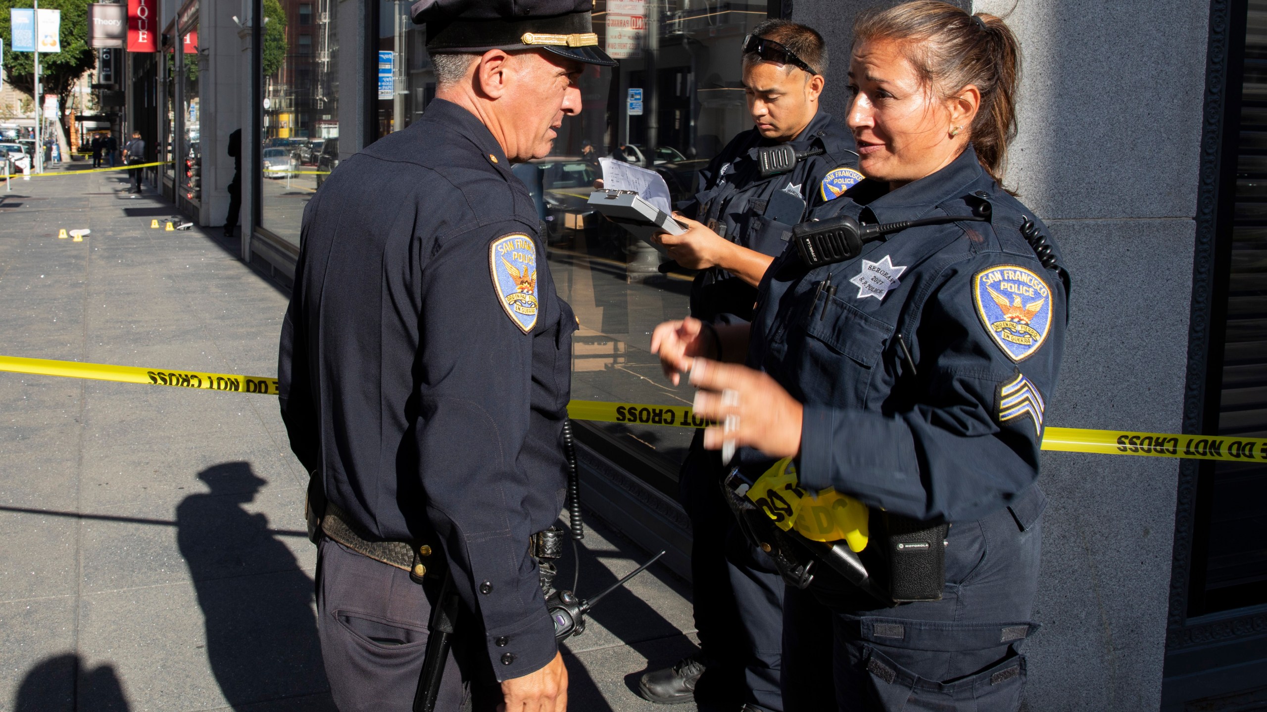 San Francisco Police Department Sgt. Joelle Harrell, right, at the scene of a shooting in Union Square, where San Francisco 49ers rookie wide receiver Ricky Pearsall was shot in the chest during an attempted robbery, Saturday, Aug. 31, 2024, in San Francisco. (Santiago Mejia/San Francisco Chronicle via AP)