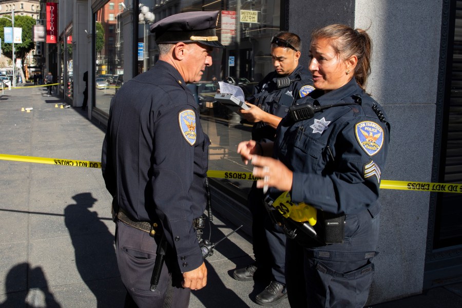 San Francisco Police Department Sgt. Joelle Harrell, right, at the scene of a shooting in Union Square, where San Francisco 49ers rookie wide receiver Ricky Pearsall was shot in the chest during an attempted robbery, Saturday, Aug. 31, 2024, in San Francisco. (Santiago Mejia/San Francisco Chronicle via AP)