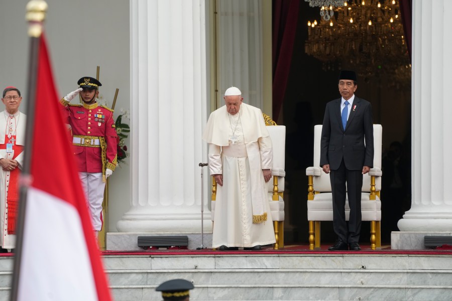 Indonesian President Joko Widodo, right, receives Pope Francis, center, at Istana Merdeka Presidential Palace in Jakarta, Wednesday, Sept. 4, 2024. Pope Francis is opening his visit to Indonesia with a packed first day Wednesday, meeting political and religious leaders and setting a rigorous pace for an 11-day, four-nation trip through tropical Asia and Oceania that will test his stamina and health. (AP Photo/Gregorio Borgia)