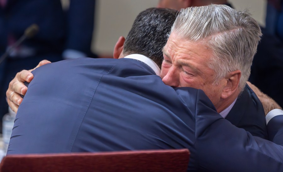 FILE - Actor Alec Baldwin, right, hugs his defense attorney Alex Spiro after District Court Judge Mary Marlowe Sommer threw out the involuntary manslaughter case, July 12, 2024, in Santa Fe, N.M., for the 2021 fatal shooting of cinematographer Halyna Hutchins during filming of the Western movie "Rust." (Luis Sánchez Saturno/Santa Fe New Mexican via AP, Pool, File)