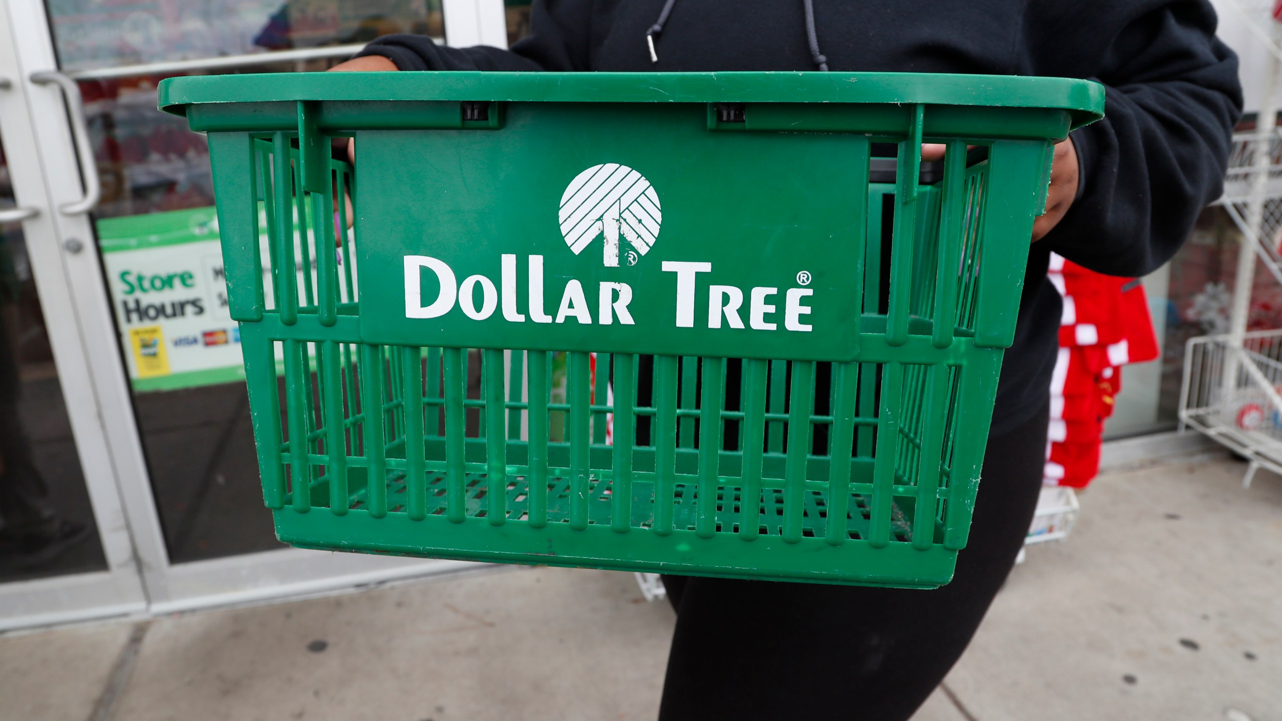 FILE - A clerk brings in a shopping basket at a Dollar Tree store in Richland, Miss., Tuesday, Nov. 26, 2019. (AP Photo/Rogelio V. Solis, File)