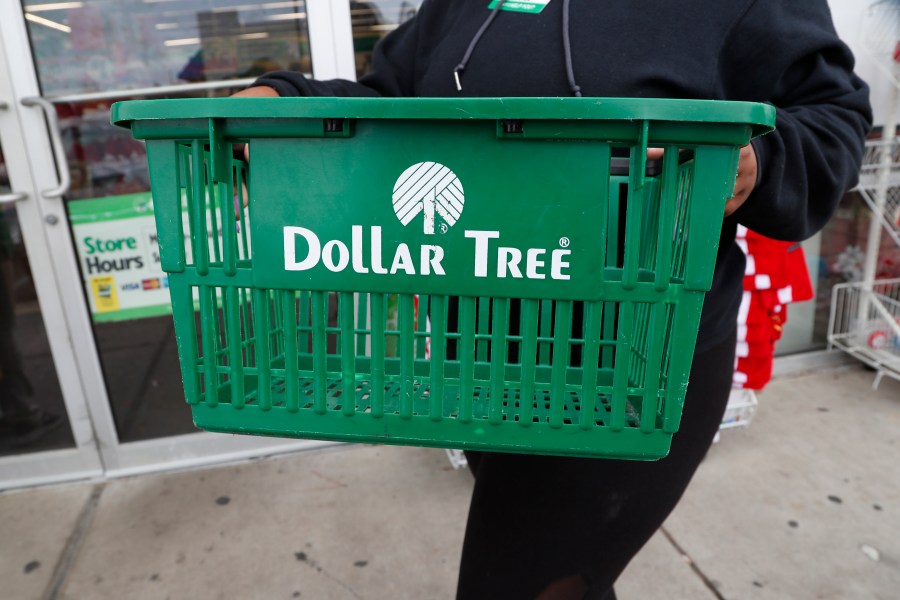 FILE - A clerk brings in a shopping basket at a Dollar Tree store in Richland, Miss., Tuesday, Nov. 26, 2019. (AP Photo/Rogelio V. Solis, File)