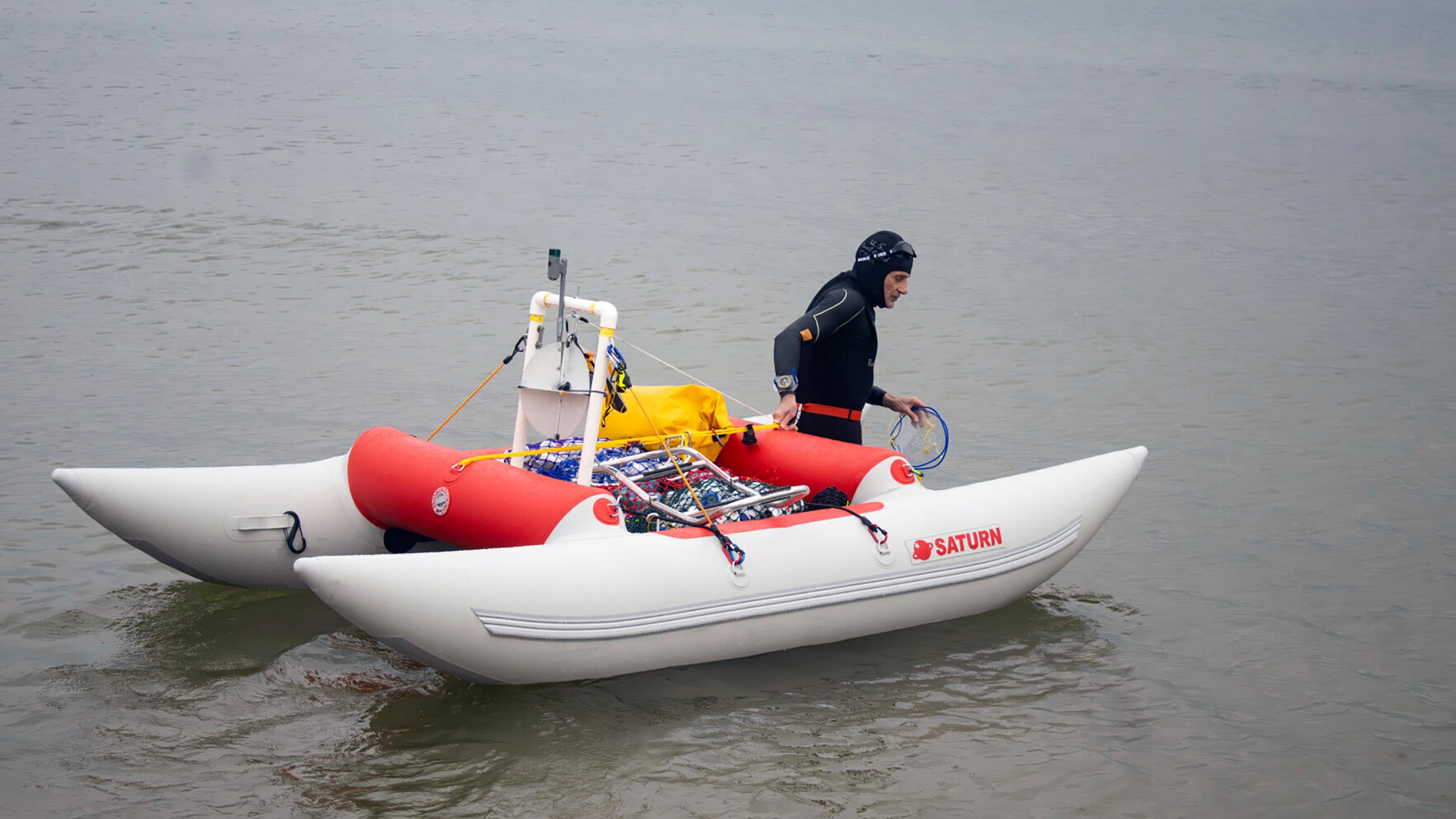 Jim Dreyer heads out into Lake Michigan in Grand Haven, Mich., Aug. 6, 2024, in his attempt to swim to Wisconsin. (Blace Carpenter/The Tribune via AP)