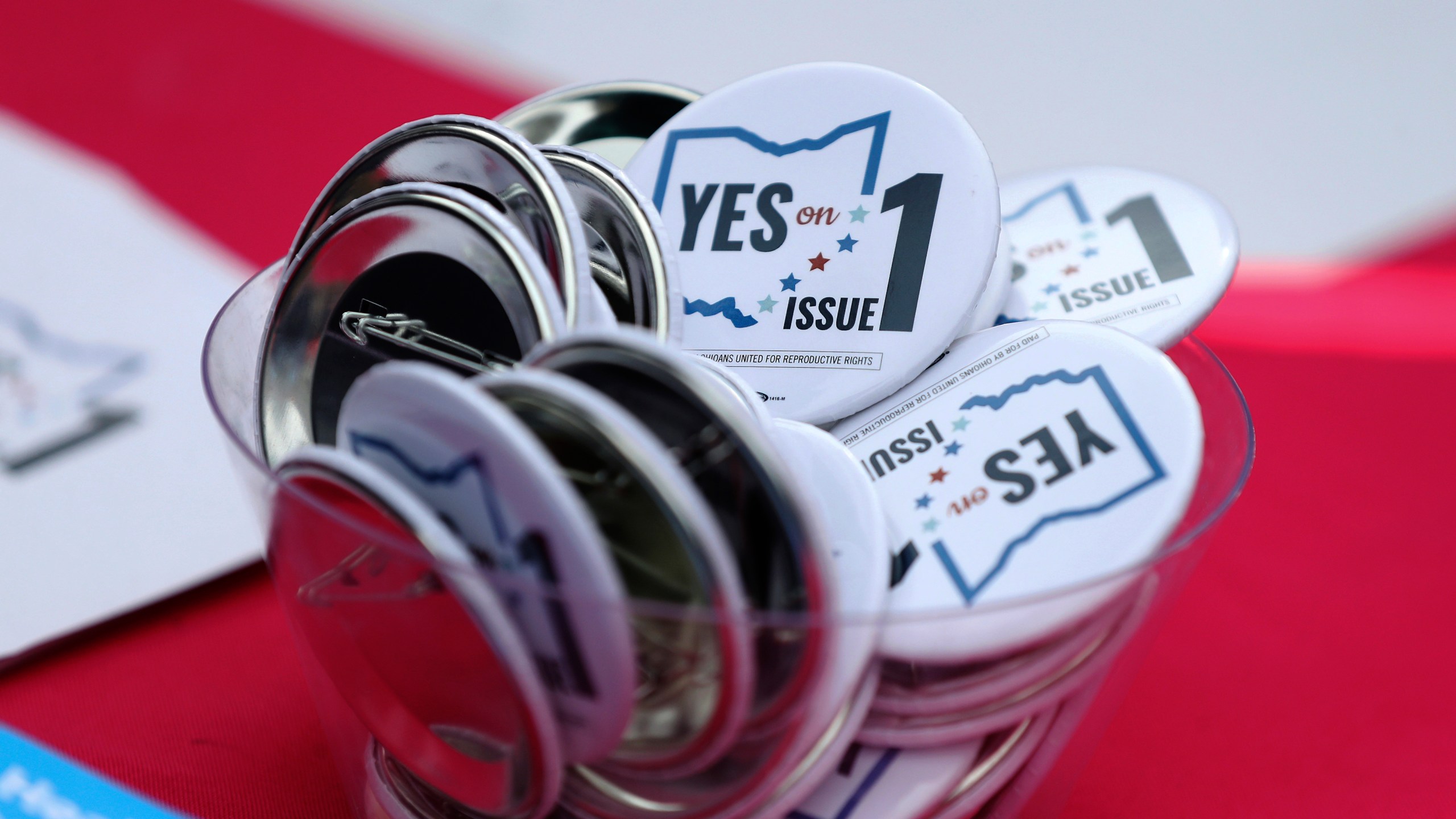 FILE - Buttons in support of Issue 1, the Right to Reproductive Freedom amendment, sit on display at a rally held by Ohioans United for Reproductive Rights at the Ohio Statehouse in Columbus, Ohio, Oct. 8, 2023. (AP Photo/Joe Maiorana, File)