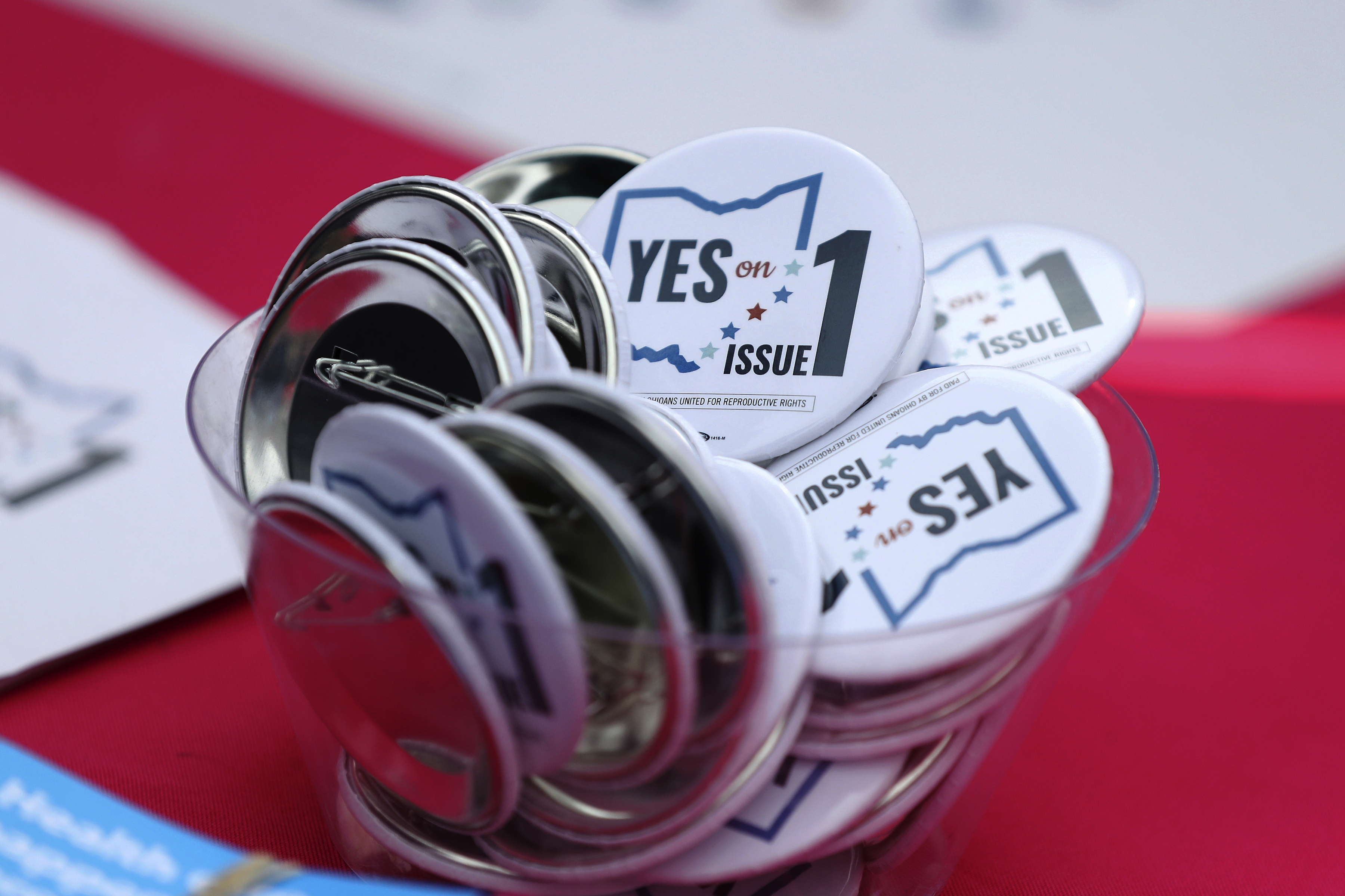 FILE - Buttons in support of Issue 1, the Right to Reproductive Freedom amendment, sit on display at a rally held by Ohioans United for Reproductive Rights at the Ohio Statehouse in Columbus, Ohio, Oct. 8, 2023. (AP Photo/Joe Maiorana, File)