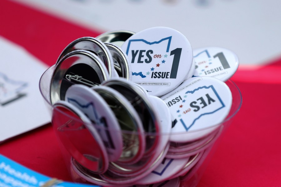 FILE - Buttons in support of Issue 1, the Right to Reproductive Freedom amendment, sit on display at a rally held by Ohioans United for Reproductive Rights at the Ohio Statehouse in Columbus, Ohio, Oct. 8, 2023. (AP Photo/Joe Maiorana, File)