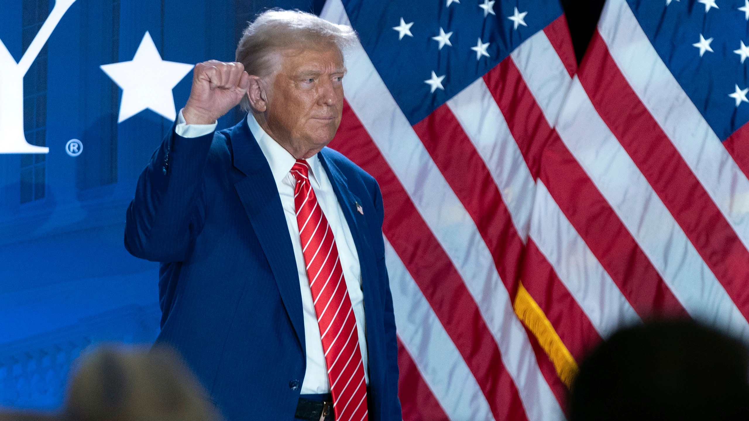 Republican presidential nominee former President Donald Trump gestures as he leaves after speaking with Moms for Liberty co-founder Tiffany Justice during an event at the group's annual convention in Washington, Friday, Aug. 30, 2024. (AP Photo/Jose Luis Magana)